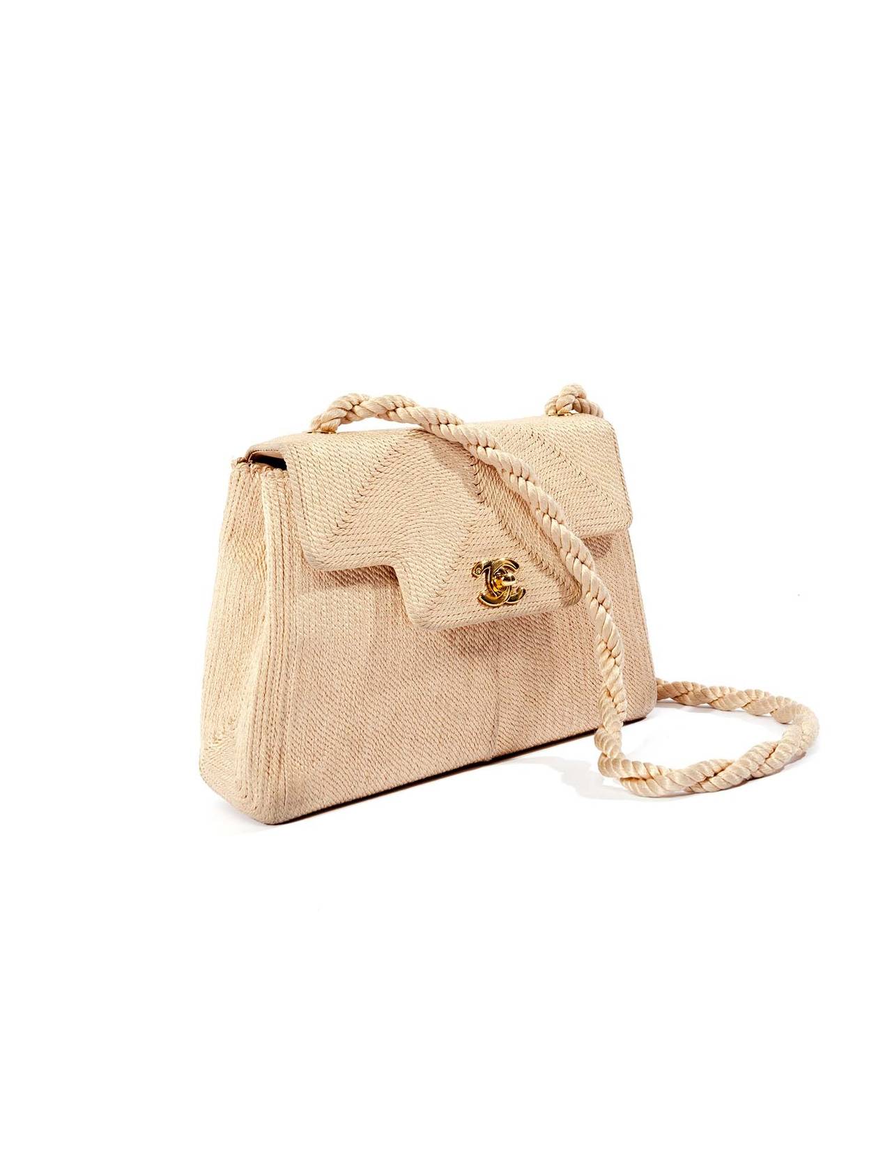 Chanel Vintage beige rope purse with gold logo double CC closure. Bag has rope straps with incredible rope chevroned details on front and back, fully lined in beige leather with small pocket and chanel logo stamped in gold. A true rare piece from