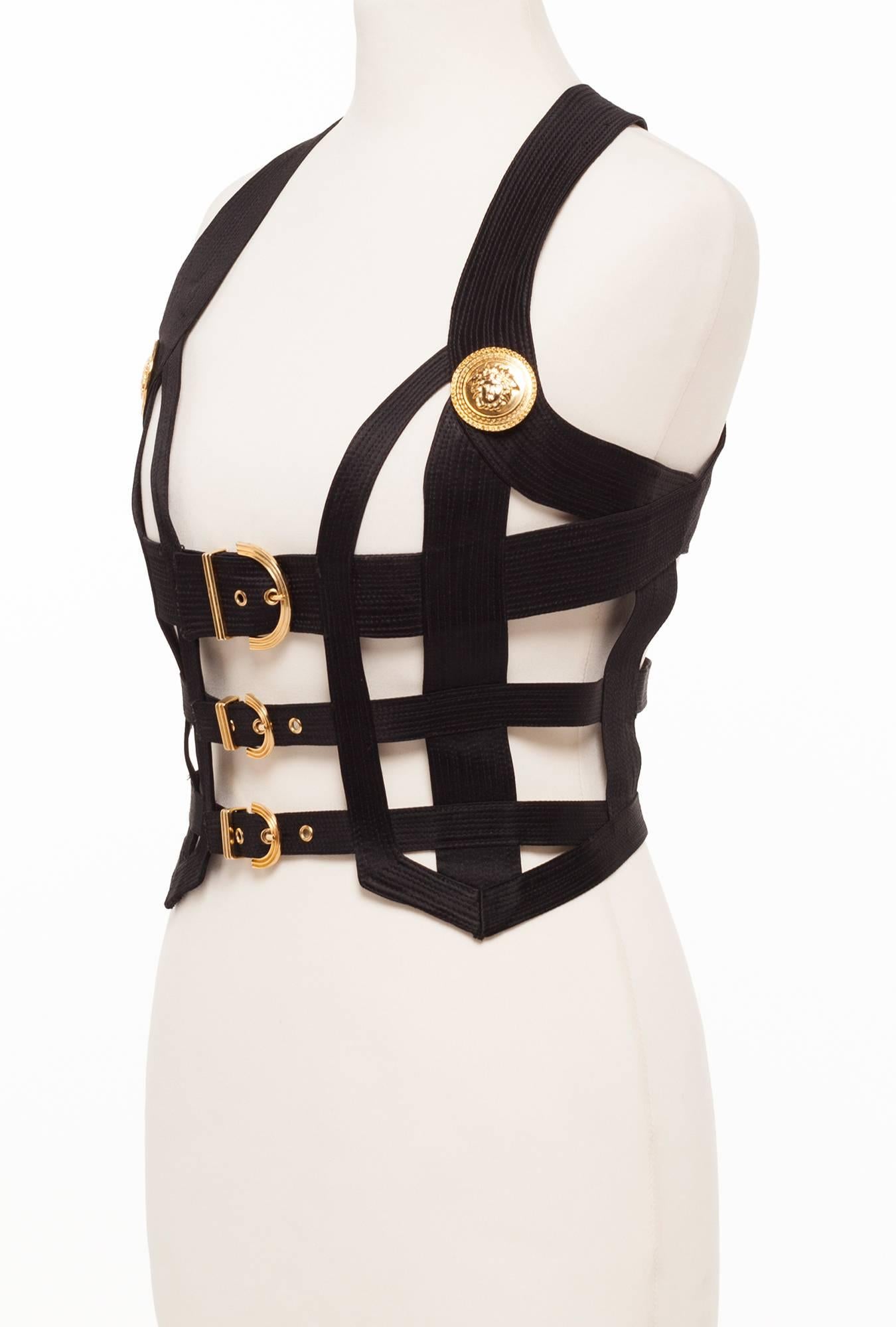 Gianni Versace Couture Bondage Bustier 1992. Bustier has all the makings of a legendary collection, The bondage collection was the hot topic on the couture runways that season, This XS Bustier has the 2 iconic medussa medallions and 3 gold buckles,