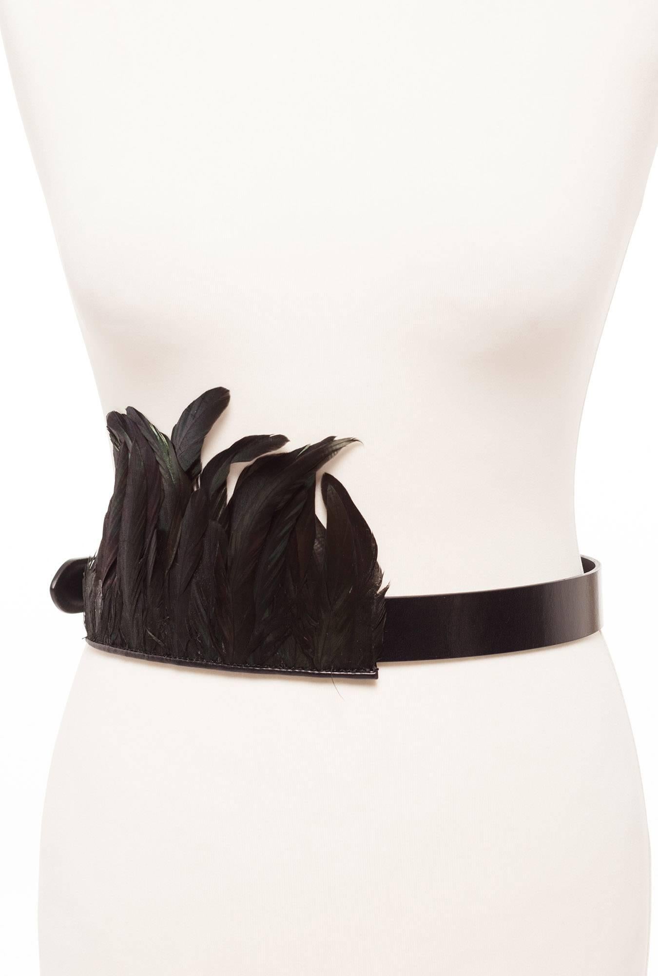Belt has exciting black feather detail that is removable and can be worn up or down and has snap with closures in back. 