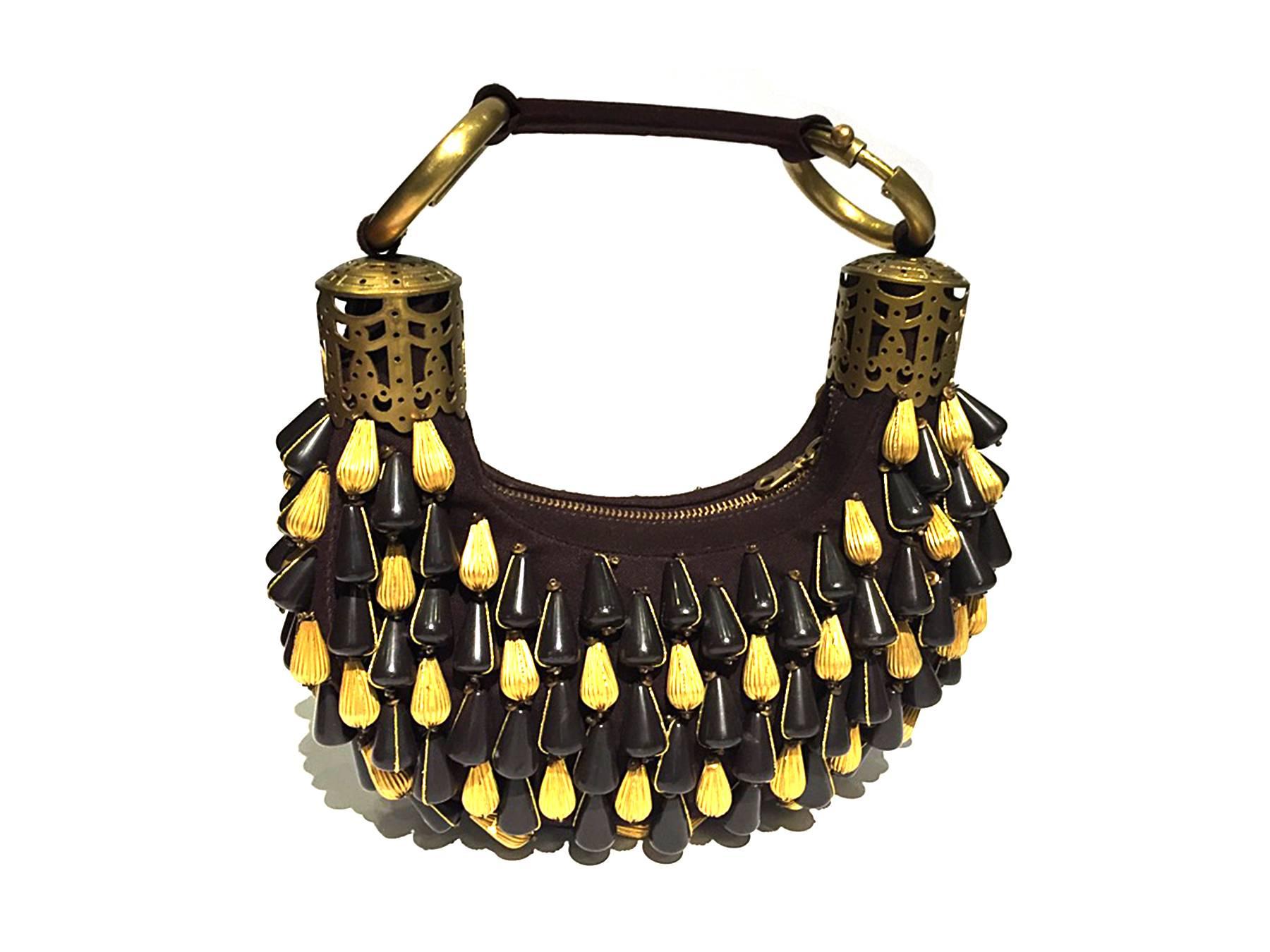 Purse has a small handle with metal lace cylinder brushed gold hardware, tear drop shaped large beads in gold and chocolate brown. A truly elegant bag for the perfect gala event. A rare master piece from the short fashion moment of Stella McCartney