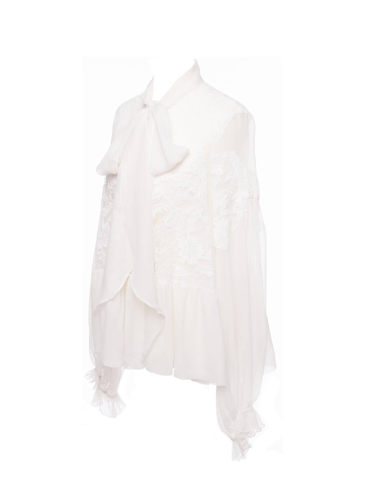 Givenchy by Ricardo Tisci silk and lace peasant blouse. Blouse has neck tie, multi white panels in lace and silk, flounced sleeve and peplum and is light and floaty.