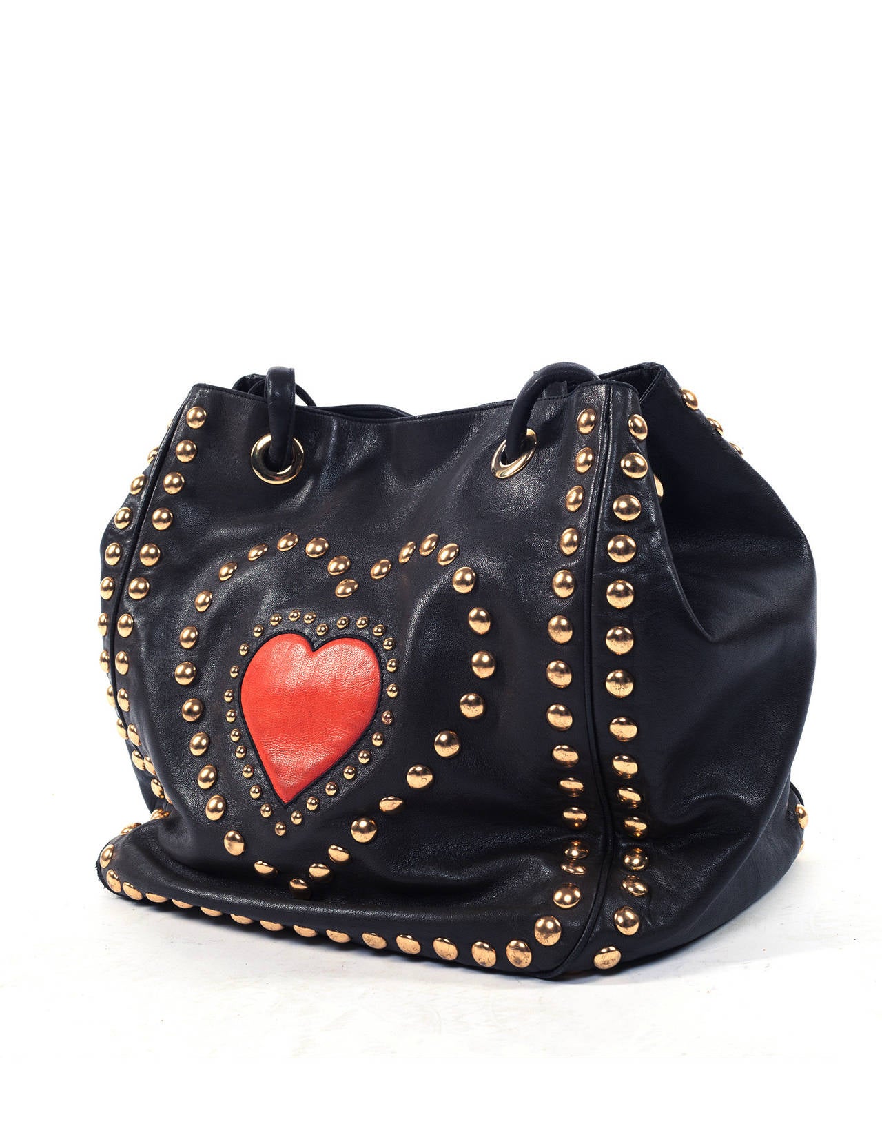 Bag is soft leather wth large red Heart surrounded by gold studs to give that fun Moschino vibe, drawstring closure with magnetic snap, fully lined in black fabric, superb leather quality. A true vintage Moschino Bag from the era of Franco Moschino.