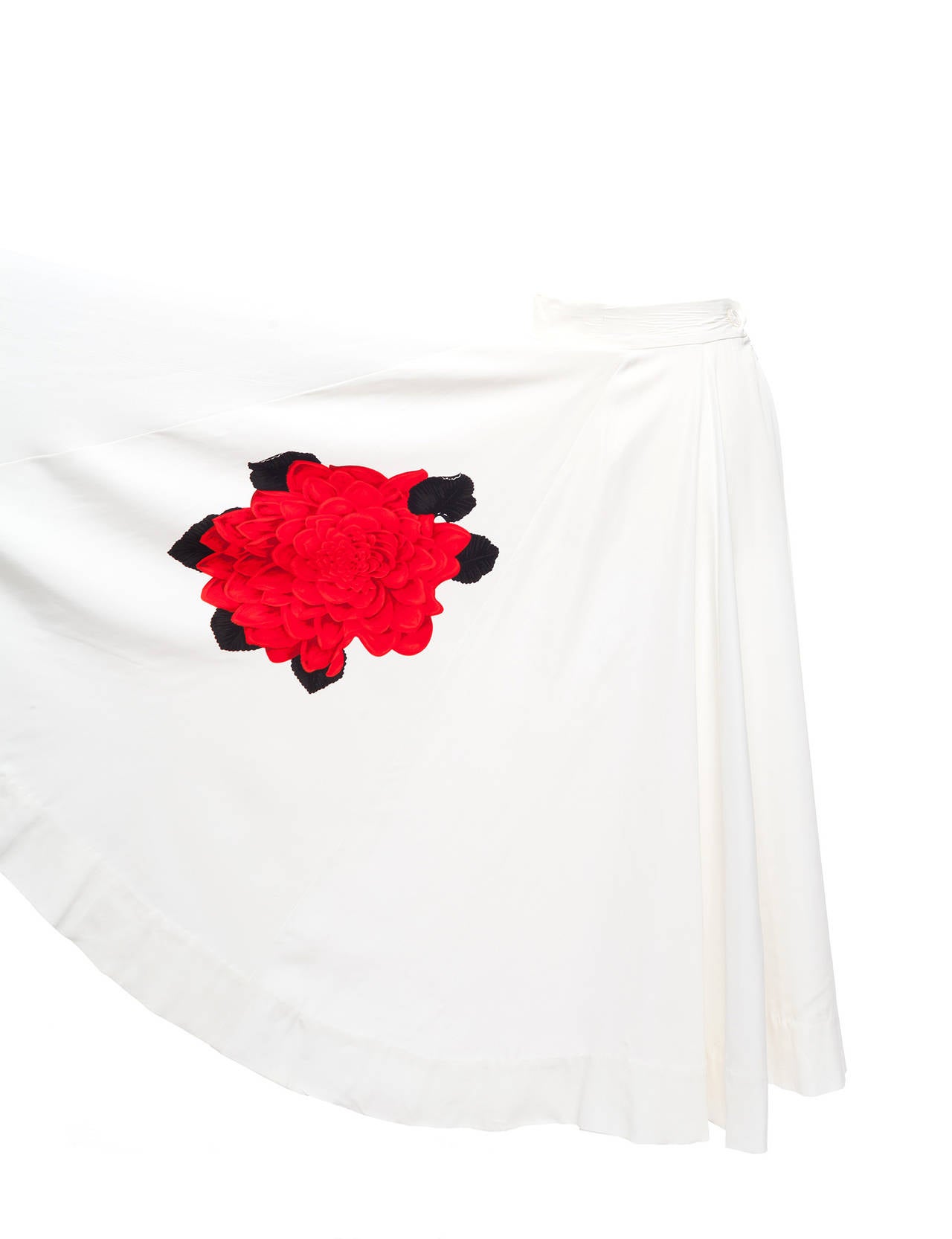 Skirt is a classic Yamamoto Merchant Ivory romantic feel, with hand painted large rose pattern on front and back skirt, high waisted, fit and flare with waist band, hand carved ivory button and side zipper.