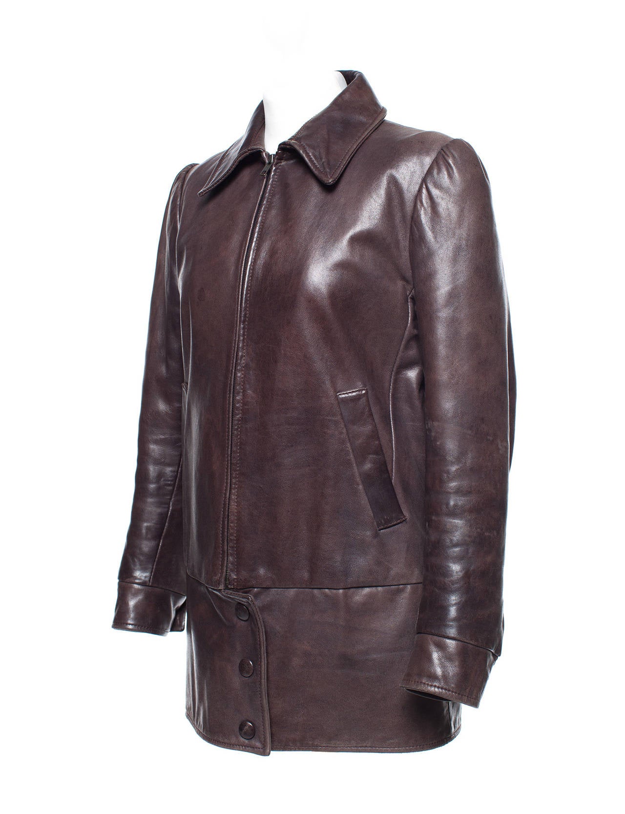 Jacket has been restyled in the shape of a dropped oversized blouson jacket. Looks like recycled leather when actually leather has been distressed to look 60 years old. The cut is similar to a women's 80's puffed sleeved evening look, but with the