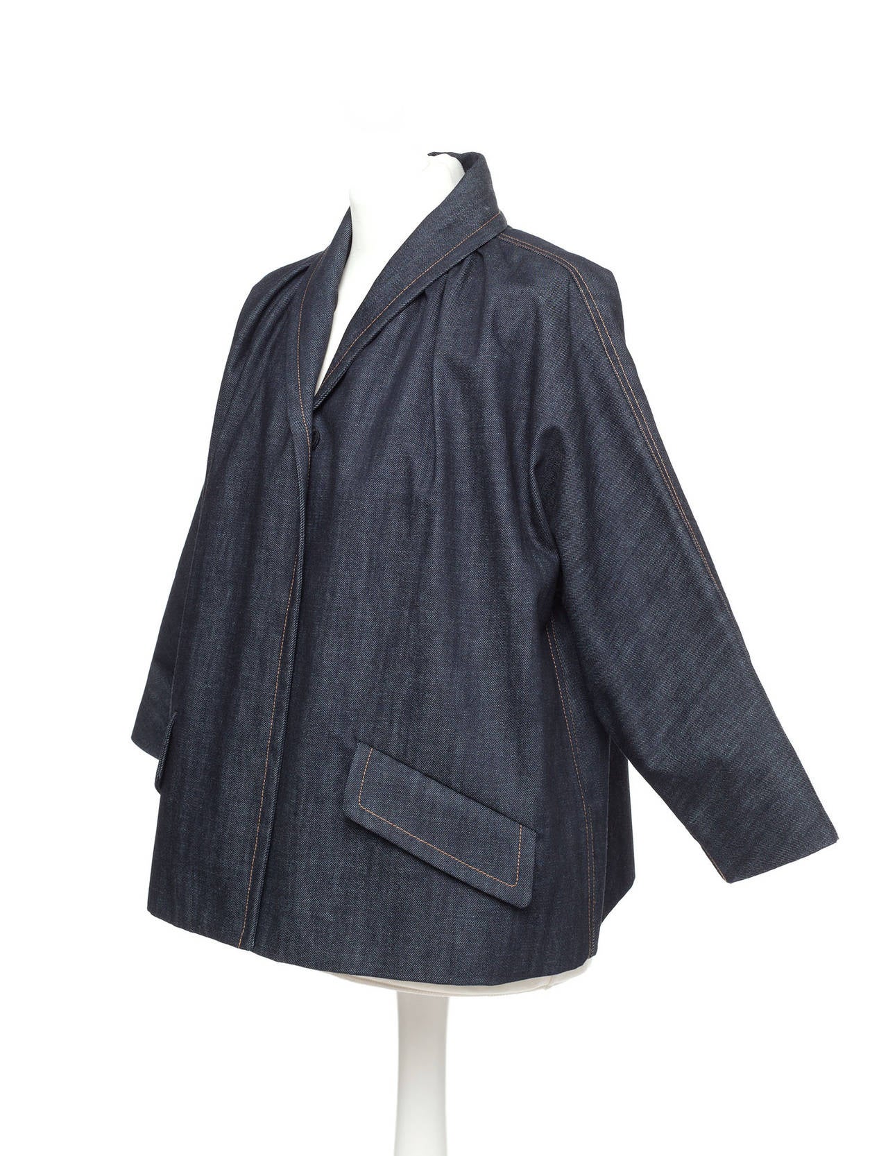 Jacket is cut aline shape with dolman sleeves, oversized snap buttons and shawl collar, 3/4 sleeves. Vintage Miu Miu denim jacket from early 2000's.