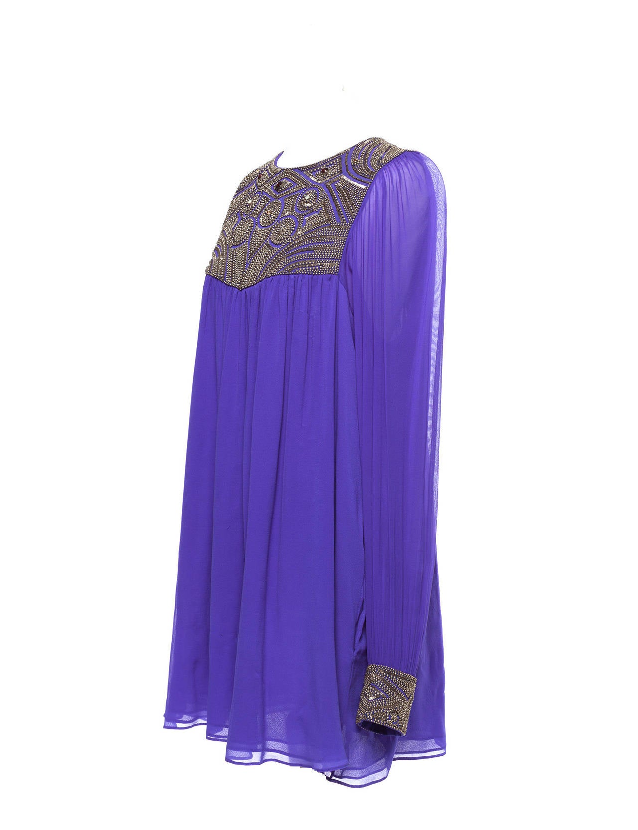 Tunic has a tunic feeling with romantic sleeves, beaded front bib, glass back button.