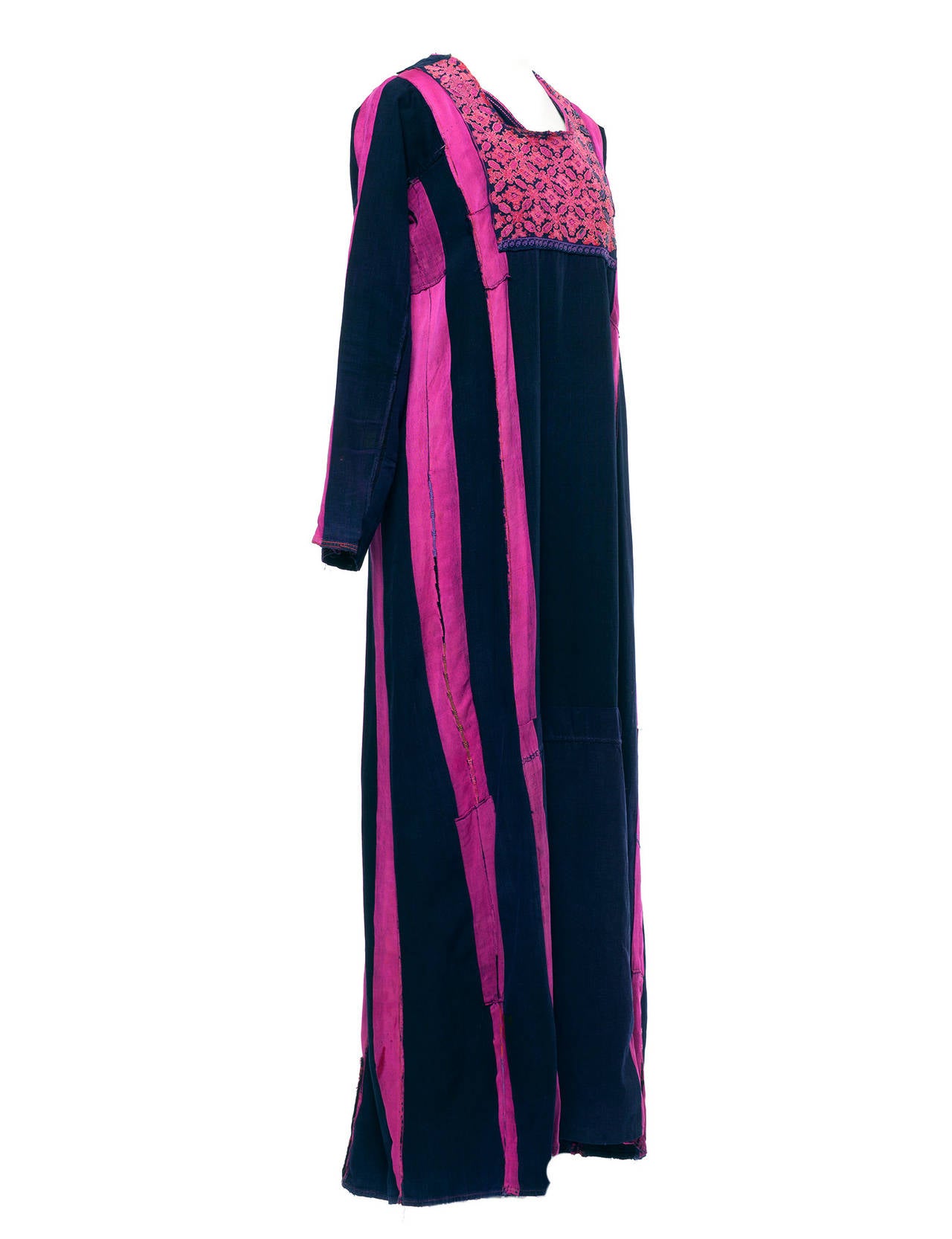 Caftan has multiple stripe indigo woven details, dyed with natural hennas, embroiderd front bid and bottom back in a traditional floral print. Not sure of year or where it comes from exactly but this piece is a beauty.