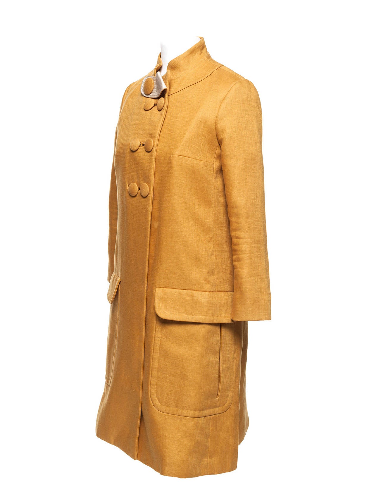 Coat has oversized button details, collar extension detail, oversized pockets and extreme narrow arms. This item is a runway sample. US 8, EU 36 more like XXS