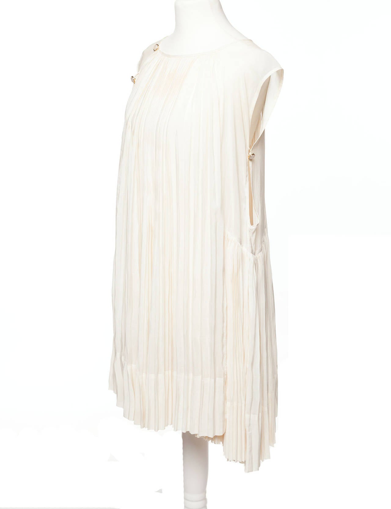 Wunderkind Silk pleated sleeveless dress with pearl buttons, There are small discoloration marks on the button placket of dress, visible only closeup.