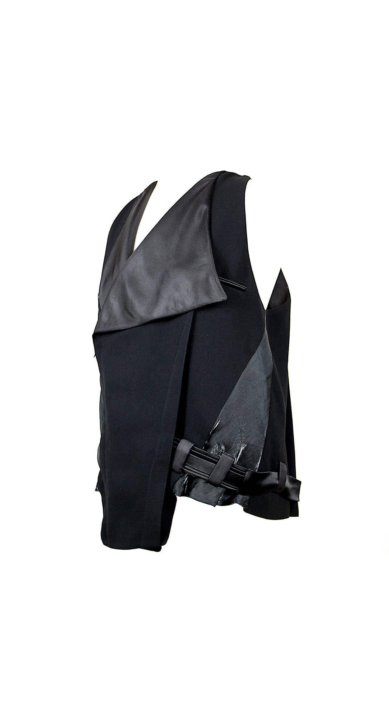 This iconic designer left an impression on modern fashion design. This vest has all the makings of a classic piece from Nicolas Ghesquière, draped crepe and satin front lapel, sleeveless dropped arm hole shape, shiny side front panels in an