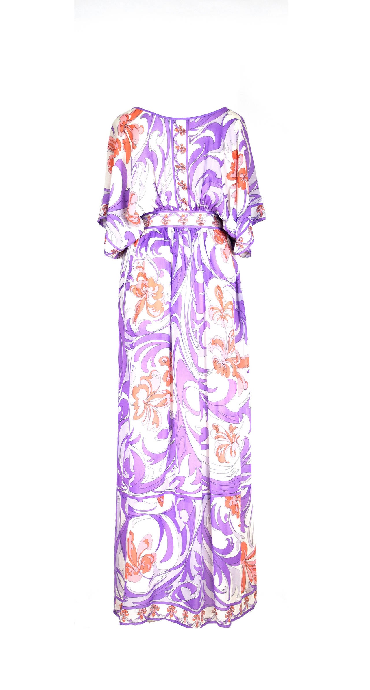 Vintage Emilio Pucci 1960's Iconic floral print dress with fitted waist and floor length skirt. Dress has butterfly shaped sleeves with a fitted yoke at waist. Scooped neck with delicate drawstring for closure. Dress has side zipper to give it that