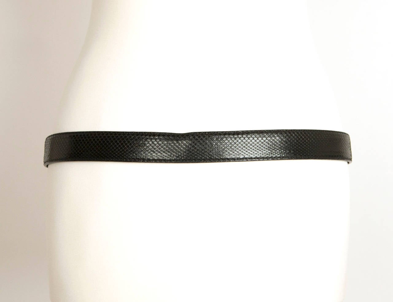 Helmut Lang vintage embossed snake belt. Belt has a stamped silver plate logo with 2 studs holding in place, the texture of belt is an embossed snake effect, silver buckle with tab detail, belt loop and 5 holes to adjust belt.