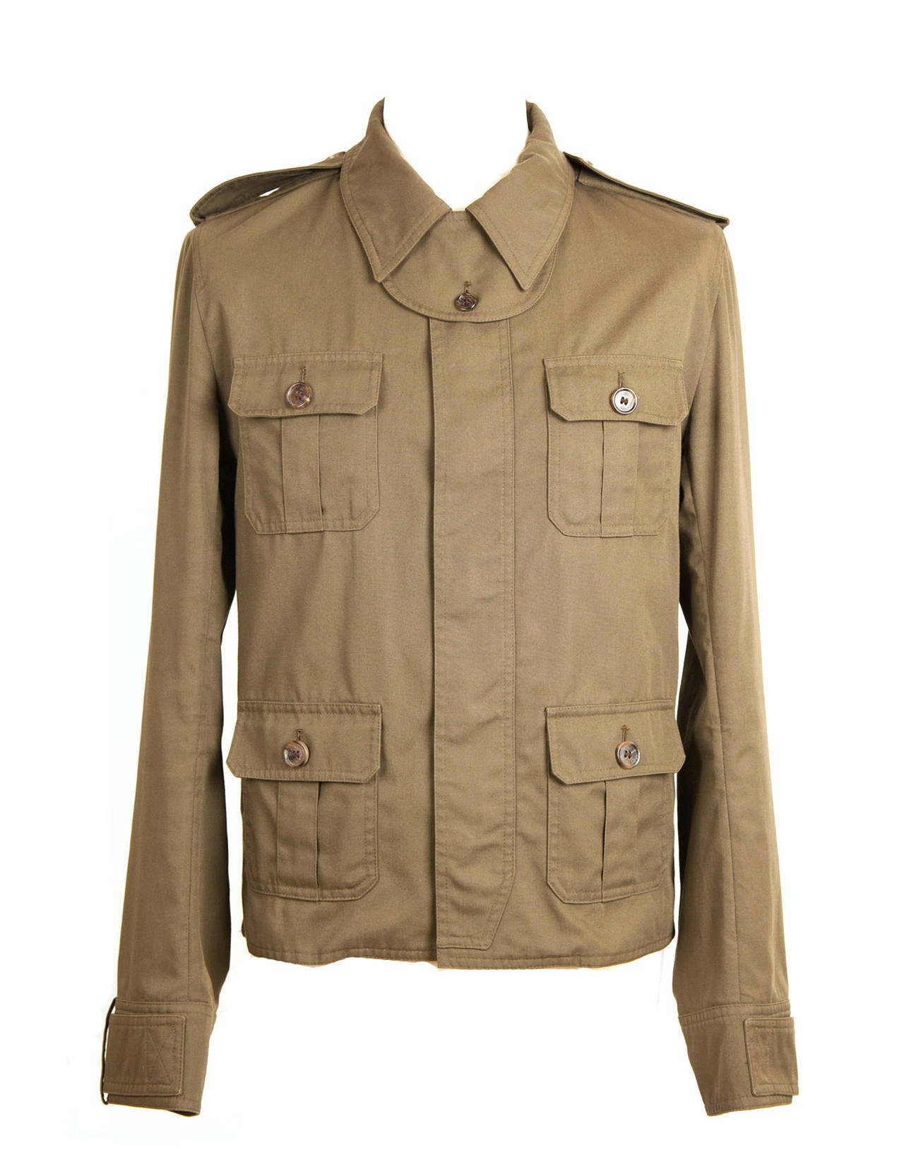 Dior Homme by Hedi Slimane khaki safari jacket from Spring 2007.  Jacket has 4 pockets in front, front removable tab at collar, back collar tab detail, epaulets, and cuffs with belt loops and buttons. Jacket is a shorter fit coming just below waist