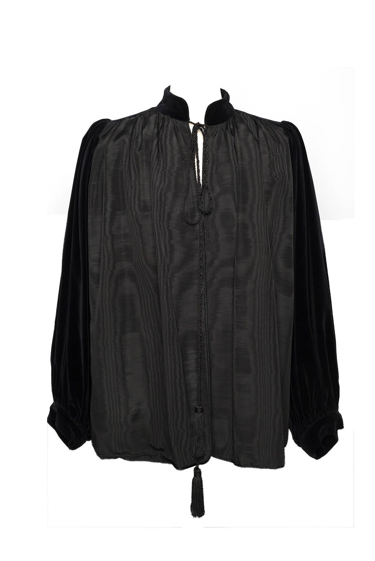 Saint Laurent Black Velvet Moire Swing Jacket from 1976 Ballet Russe Collection. A Rare vintage classic form the master of color Yves Saint Laurent. Jacket is trapeze shape with black moire fabric front and back, billowing black velvet sleeves and 