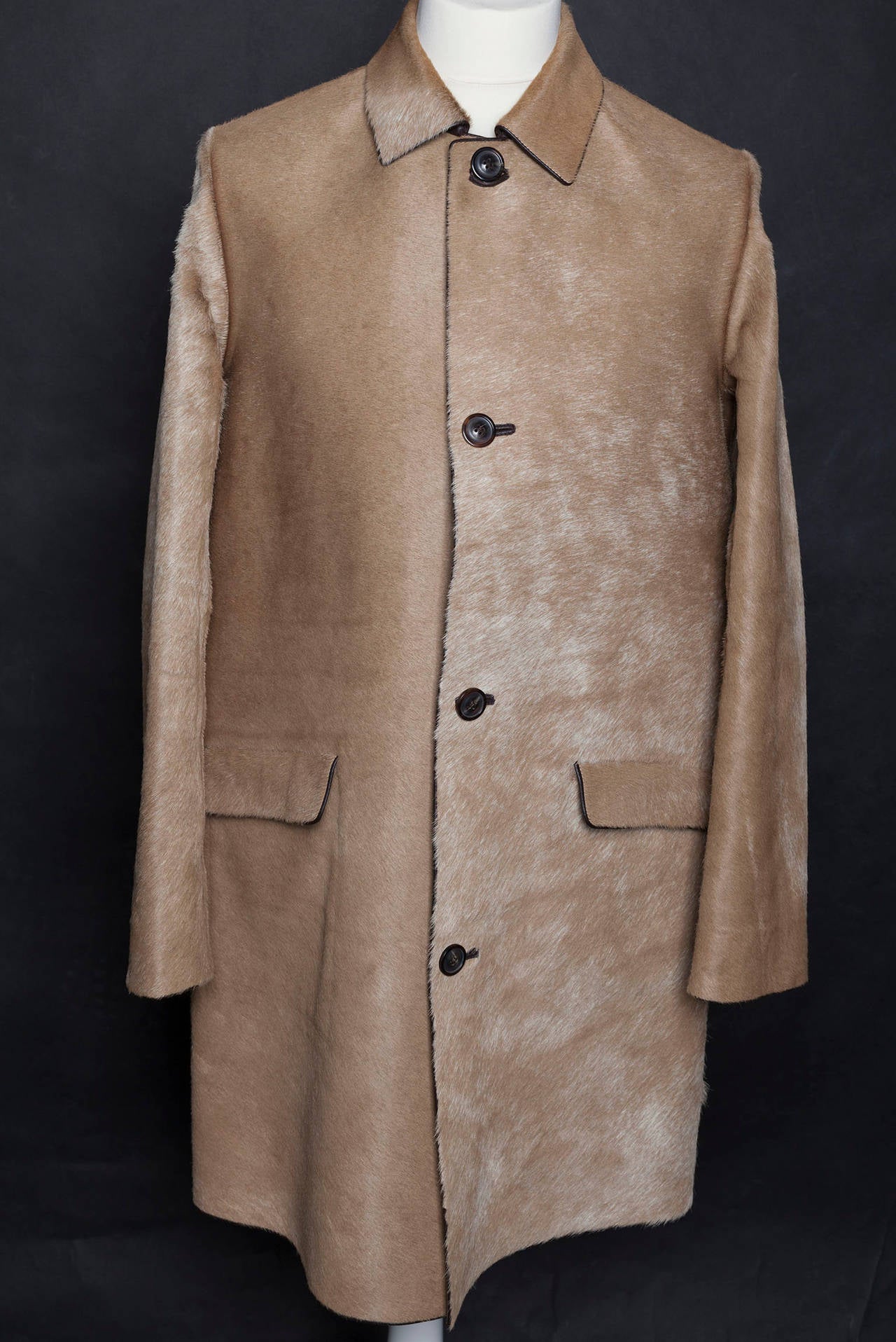 Maison Martin Margiela Mens (14) 'Replica Series 07' Ponyskin Trench Coat. Heavy ponyskin coat in a tan and cream colour way with chocolate brown leather trim and lining. Simply cut with a slight a-line silhouette and finished with polished horn