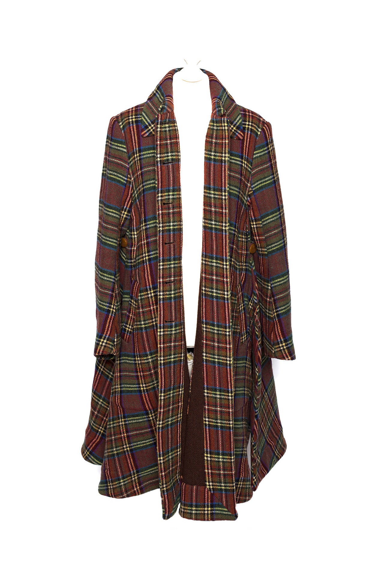 Vivienne Westwood Vintage 1990's brown multicolored trapeze coat. This coat is spectacular for any Westwood fan, Plaid fabric is in browns, greens and blues, oversized trapeze fit, classic orb buttons and is completely lined in harris tweed wool,