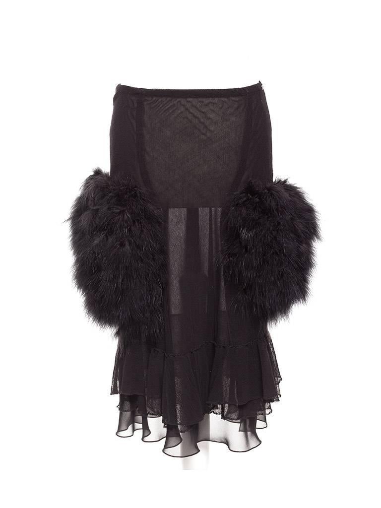  Skirt is fitted and cut in stretch black mesh with 2 layered flounce at hem, oversized pockets covered in Marabou feathers. Lining in black crepe.