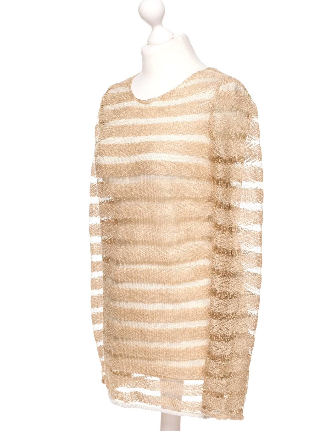 Pullover comes in gold and sand tones, with peek a boo stripe details. 