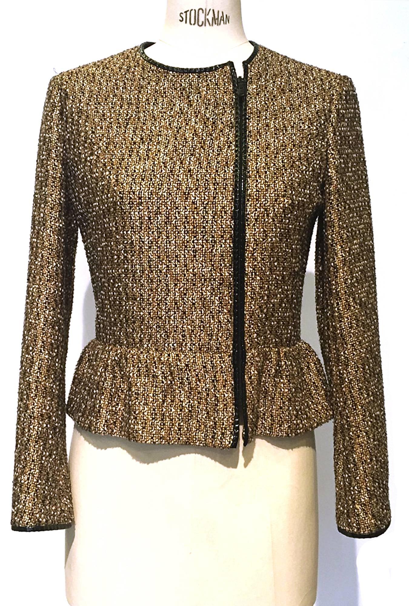 Blazer comes in a mix of mustard, black, ecru and gold woven boucle, front is asymmetrical with black patent leather trim around front neckline and sleeves, front side hidden zipper, slight pepline at waist and is fully lined in silk, a chic take on