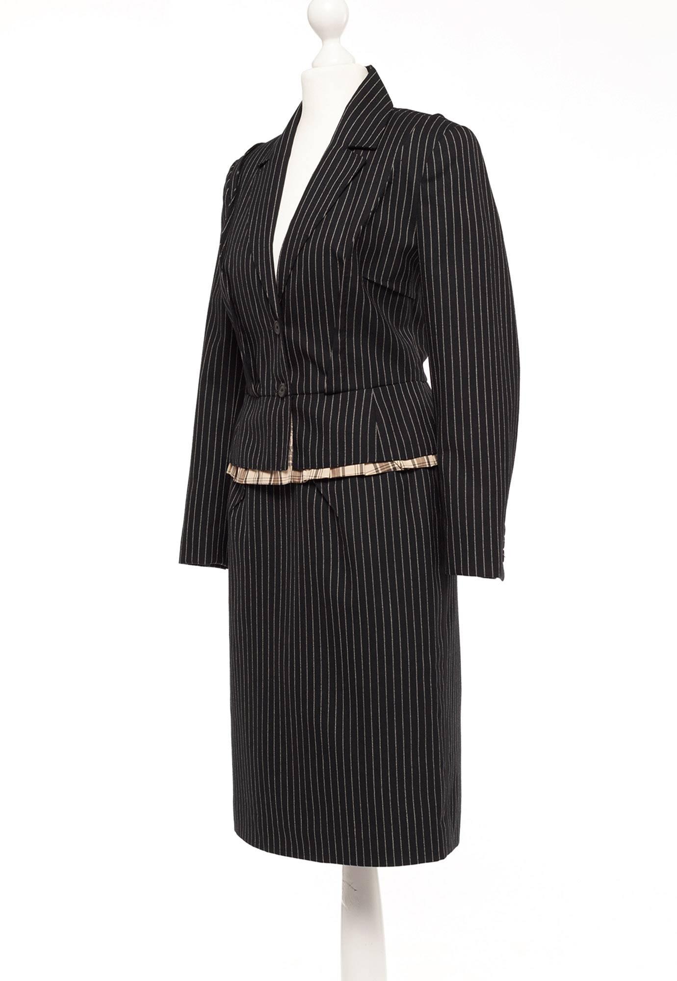 Blazer is cut above hip with peplum, shoulder dart details, Blazer in lined in a brown tone tartan plaid, slightly exposed at hip hem. luxurious fabric. Skirt is pencil shape, with interesting dart details front and back. 50's style with the Marc