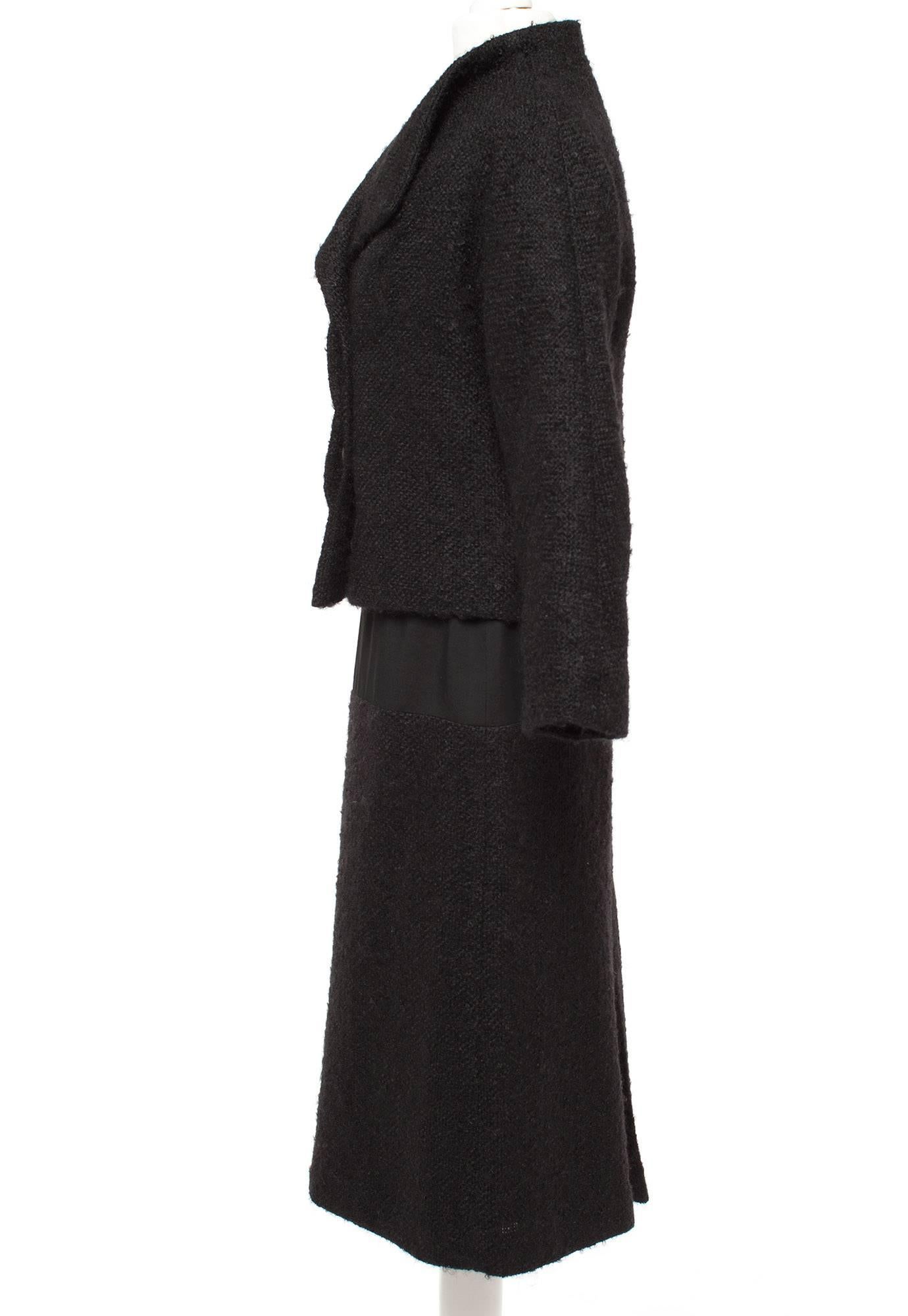 Jacket is short, cut just below waist, fold over collar, 3/4 sleeves. Skirt is pencil shape, top skirt in gabardine, bottom skirt in Boucle wool.