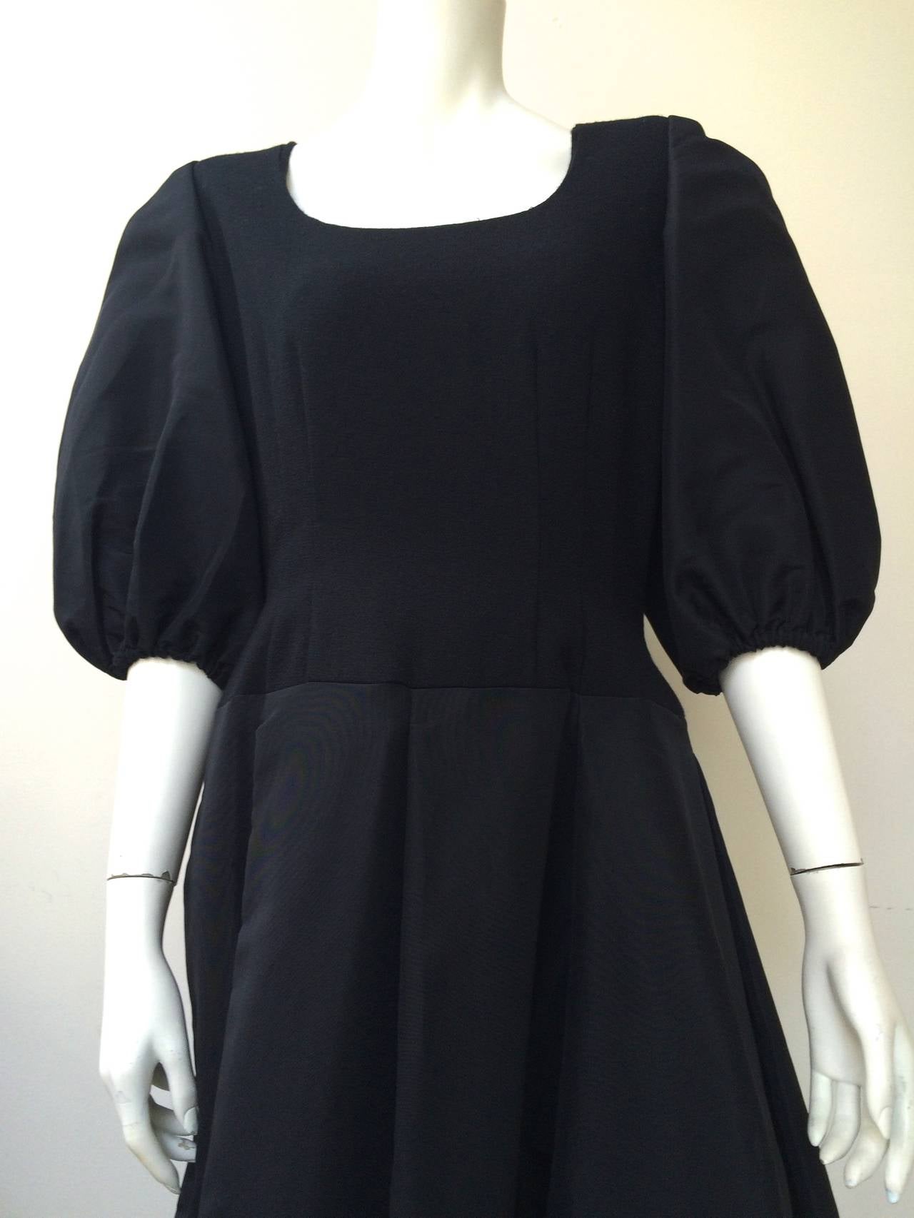 Pauline Trigere 1980s black wool & silk taffeta cocktail dress made in the USA. Bodice is wool, sleeves are silk taffeta.  Skirt is silk taffeta and trimmed in wool. Elastic sleeves. This is a fine example of Pauline Trigere's work, her clothes are