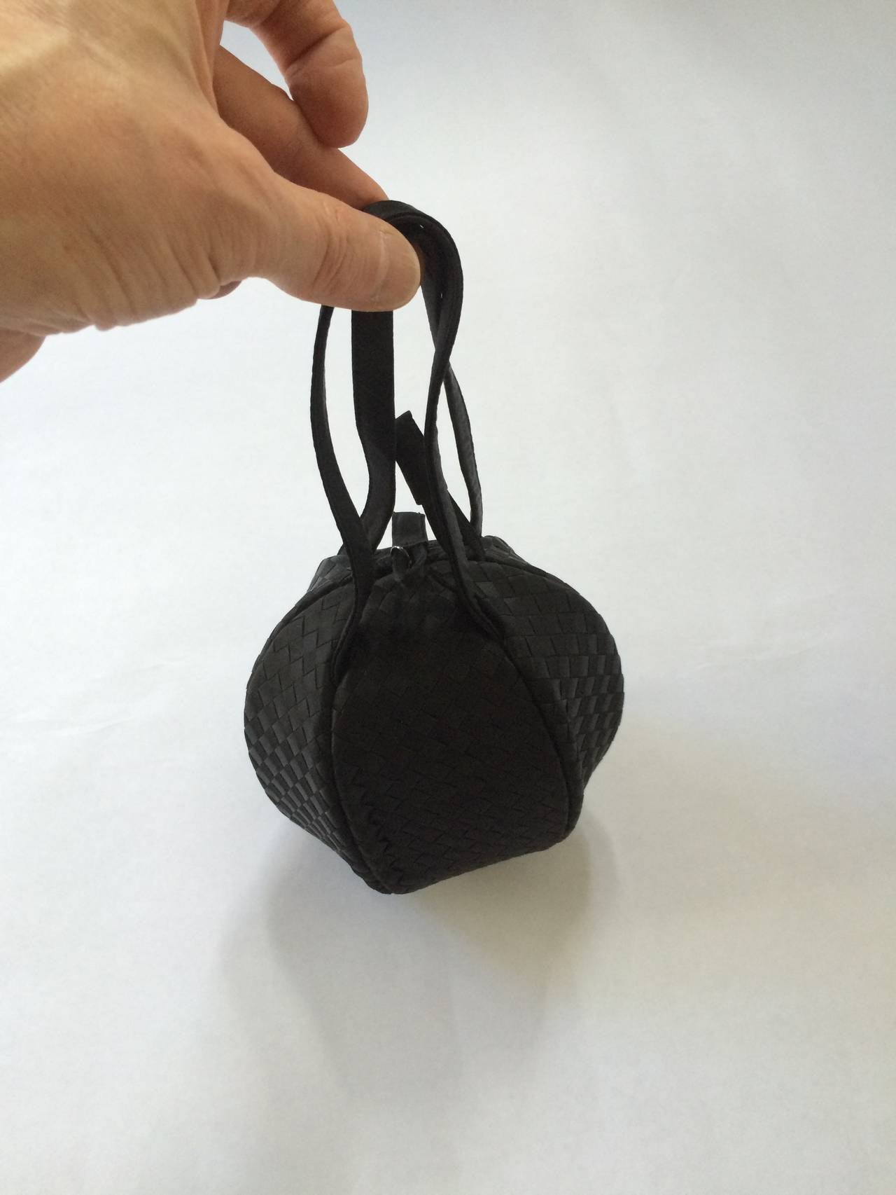 Bottega Veneta 90s silk woven round evening bag made in Italy.  This round woven evening bag was a rare / unique design and not a lot on the open market. Bottega Veneta has created a new standard of luxury since its founding in Vicenza in 1966.