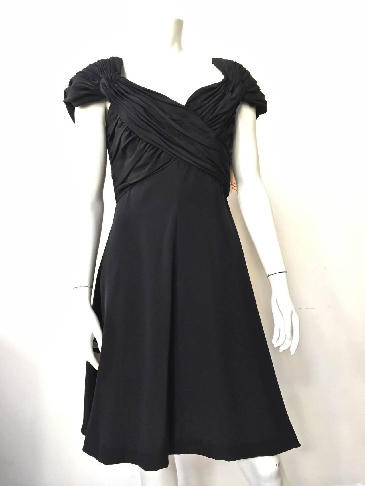 Scaasi 80s silk little black dress still with original price tag of $2,180 and a size 12 but fits like a size 6 today. Please see measurements below.  Made in the USA. This is one gorgeous & sexy silk dress, it is timeless but what you expect from