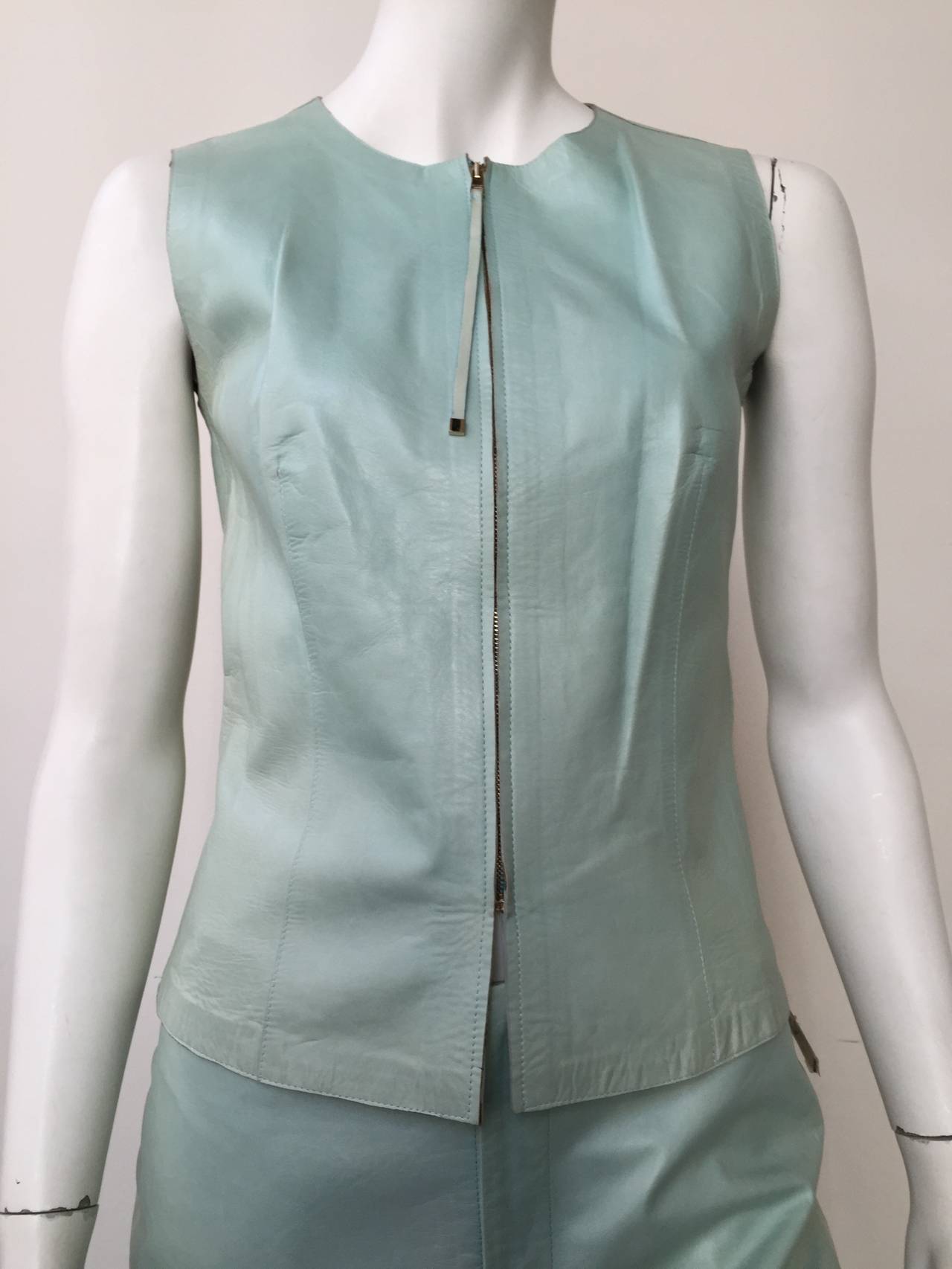 Gucci 90s for Neiman Marcus designed by Tom Ford 2 piece aqua leather vest & pants still with original tag. Vest is a zipper front with long skinny pull tab with Gucci written on it. Vest is not lined. Vest size tag says its a size 40 or USA size 6