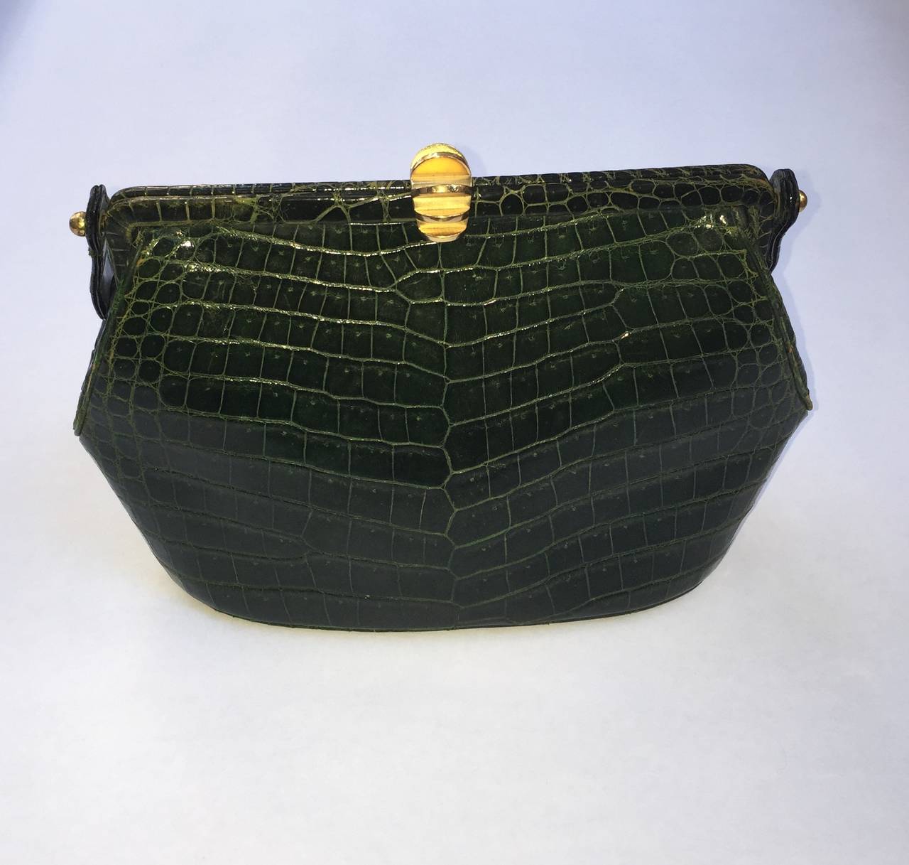 Coblentz 70s green crocodile handbag with strap and brass abstract clasp. The strap is in working condition but will soon need a new one but that is a minor repair on such a lovely and timeless handbag.  The measurements are:
10