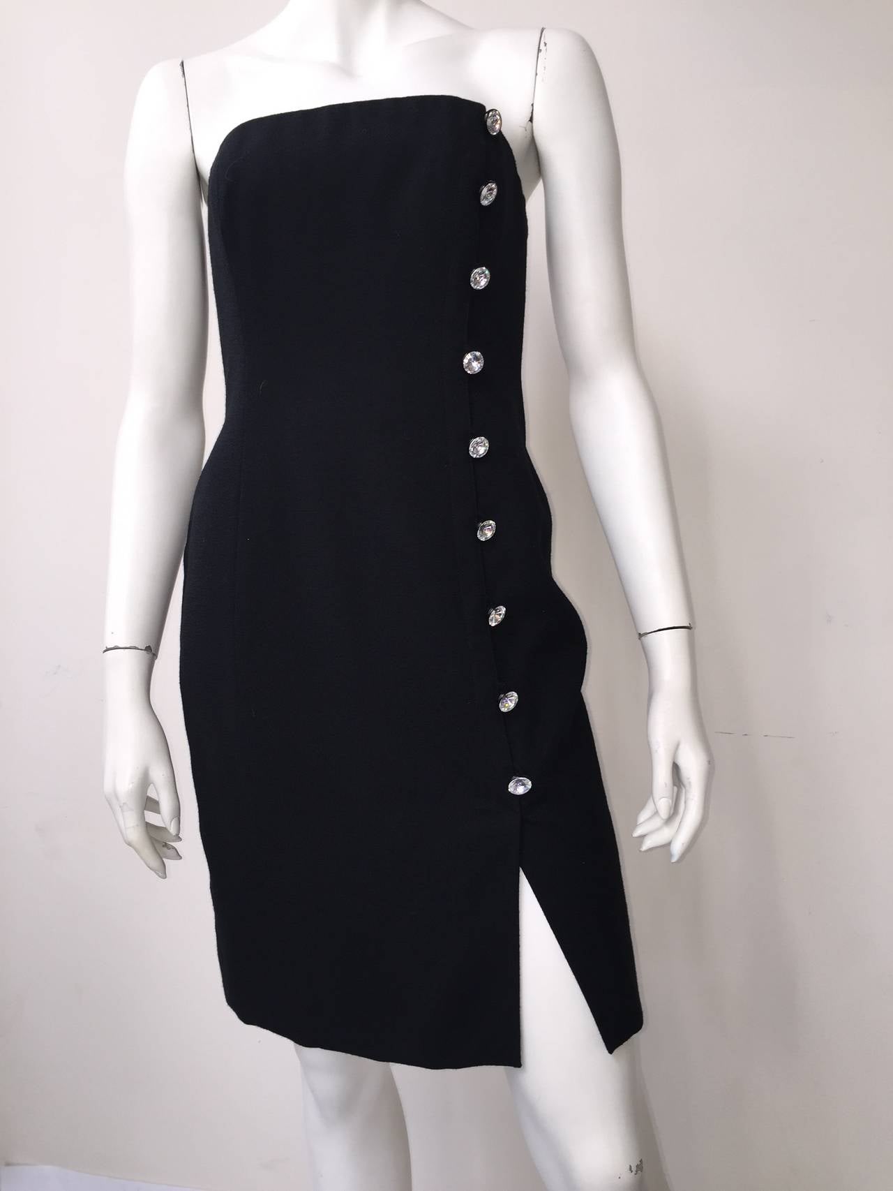 Tom and Linda Platt 80s strapless wool cocktail dress size small (6). 
There are 9 large rhinestone buttons on left side of dress. 
Sexy slit on front of dress. 
Dress is lined and the boned bodice is lined in linen. 
This little black cocktail