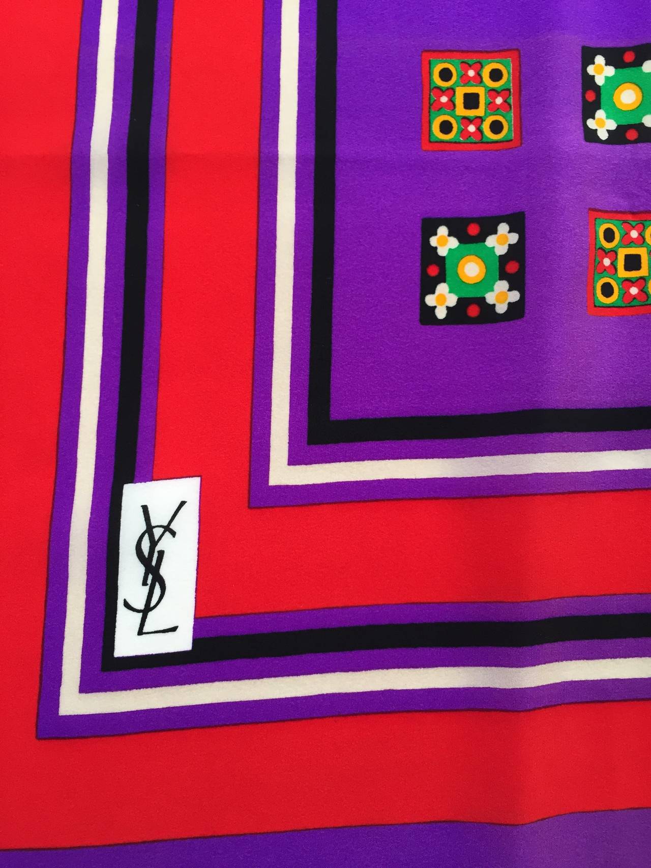 Yves Saint Laurent 1980s silk scarf size 31.5" x 34".
Hand rolled edges.
Red, purple, blue, black, mint green colors all create the most amazing modern design scarf. Perfect for your little black dress to add a splash of panache.
