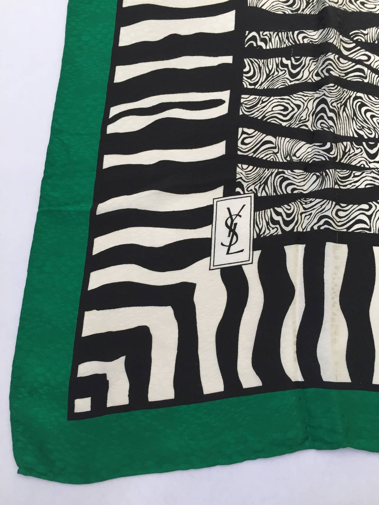 Yves Saint Laurent 80s zebra print silk scarf with green trim and hand rolled edges. 
34