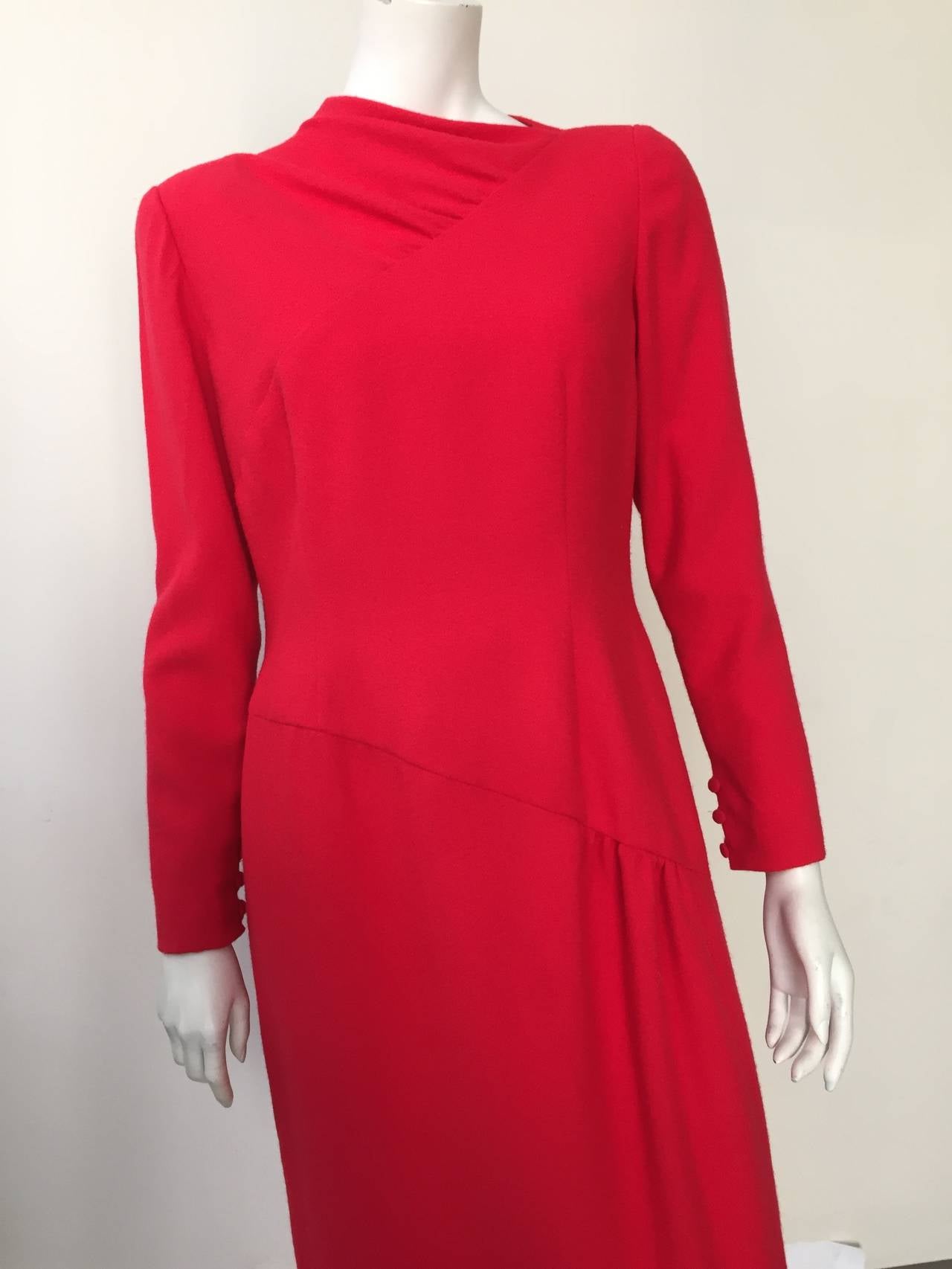Bill Blass for Neiman Marcus 70s red wool dress asymmetrical cut at neckline & waist is a size 12.  Ladies please use your measuring tape to properly measure your lovely body to make certain this will fit you to perfection.
Dress is lined. 
There