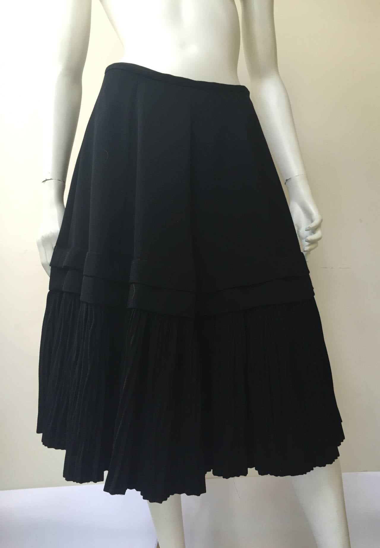 Comme des Garcons by Rei Kawakubo for Bergdorf Goodman 80s black wool pleated bottom skirt size medium. Made in Japan. 
Skirt is lined.
Zipper on side.
Measurements are:
27
