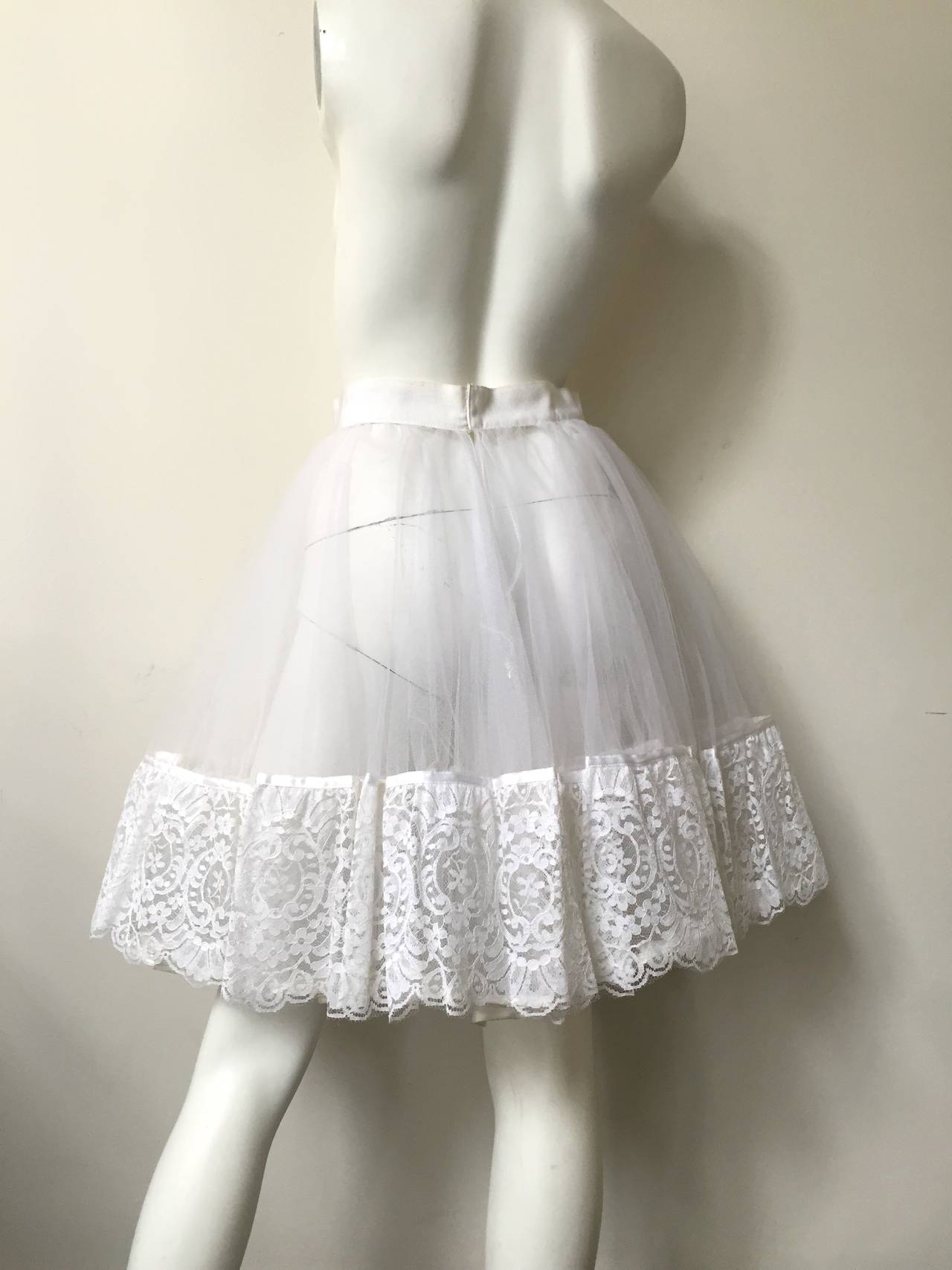 Emanuel Ungaro Parallele Paris see-through layered tulle with white lace trim petticoat size small. 

White cotton waist trim.
There are 3 layers of netting.
Made in Italy.
This was purchased in Dallas Neiman Marcus in the 80s for over