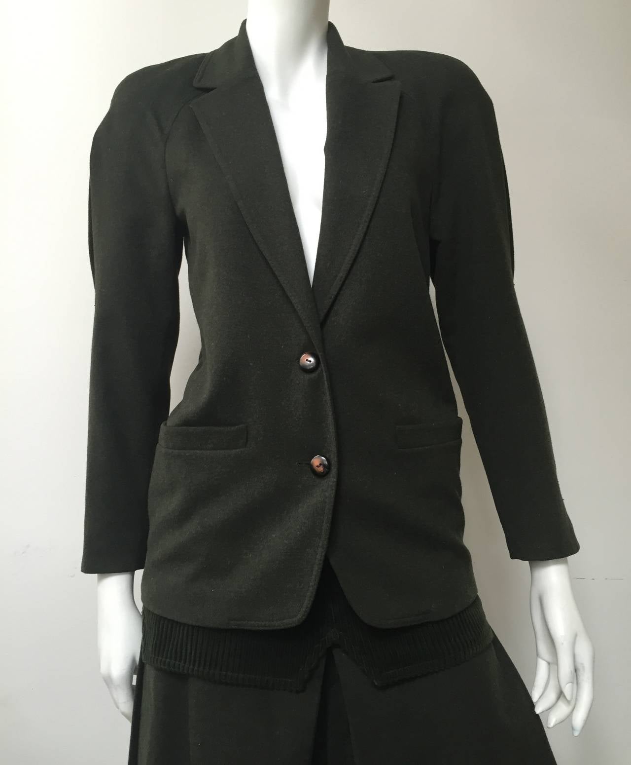 Gianni Versace 80s green wool jacket & gauchos size 38 or 4 USA,  made in Italy.
Inverted pleat on both sleeves and in back of jacket.
Gauchos have pleats on both sides.
Corduroy fabric at waistline of gauchos.
Measurements are:
Jacket: 
38