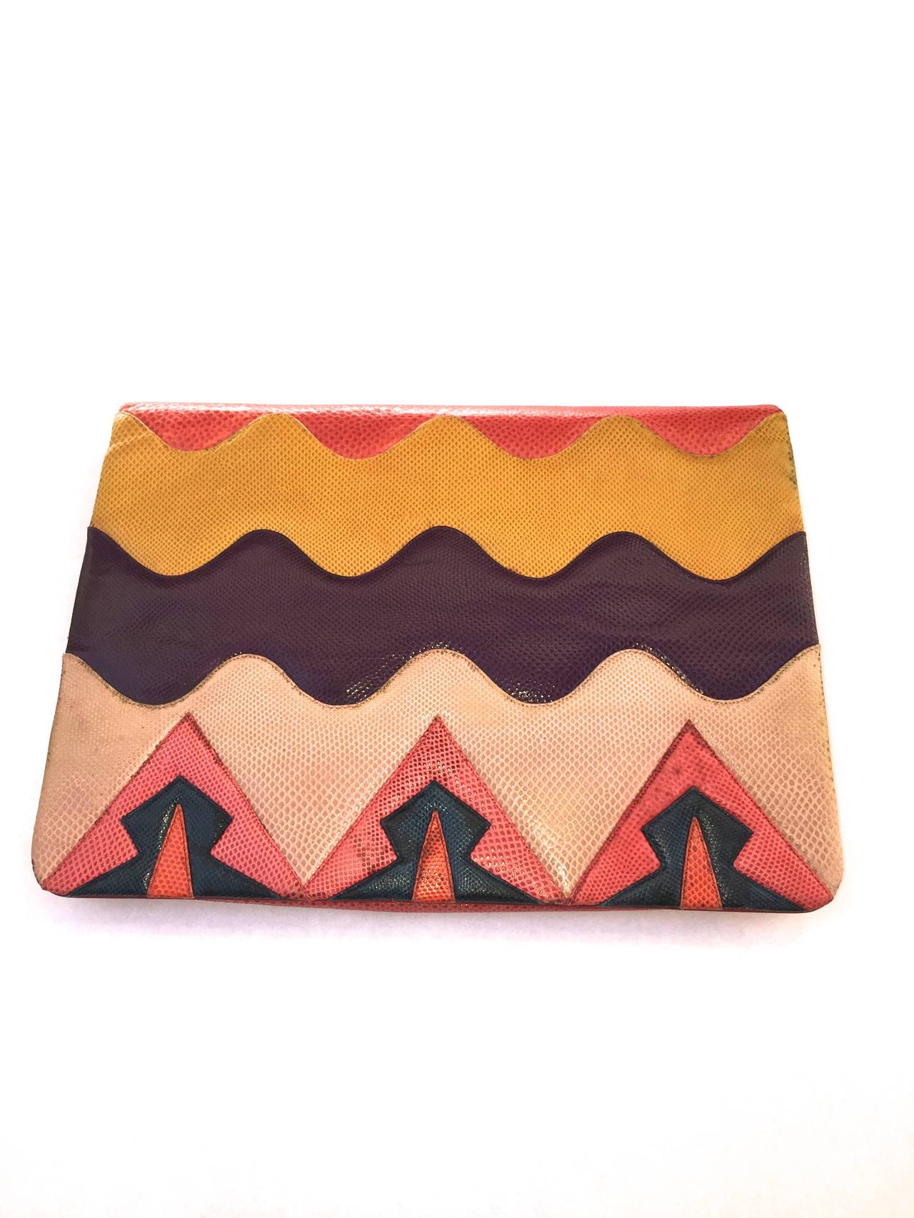 Judith Leiber 1980s geometric Karung clutch.
Bright spring / summer colors such as purple, yellow, pink, orange and red.
Missing the detachable shoulder strap but perfect as clutch.
There are two sections inside that are lined and the inside front