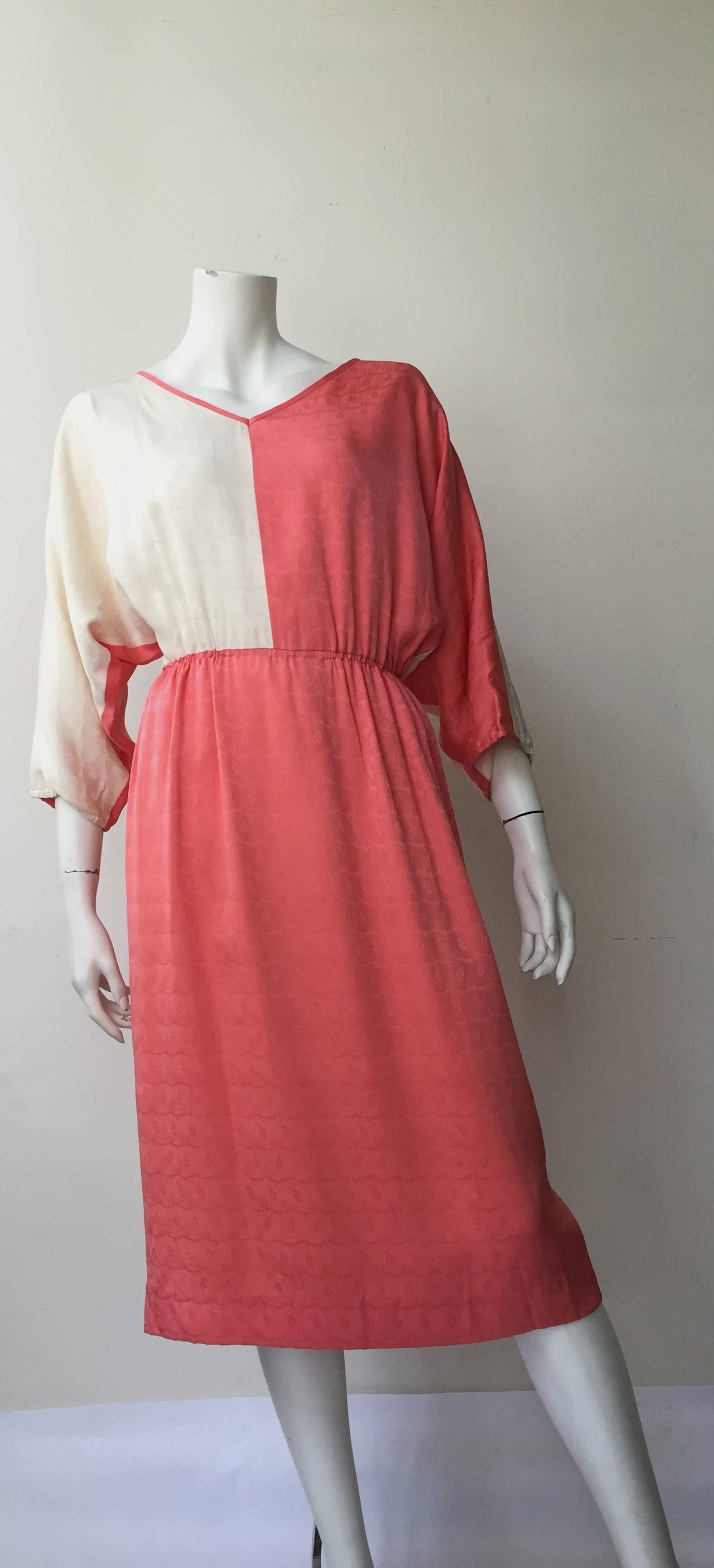 Mr. Blackwell Design 1950s coral & cream silk dress with dolman sleeves and elastic waist is a vintage size 14 but fits a modern USA size 8.  Ladies please use your measuring tape to properly measure your bust, waist & hips to make certain this will