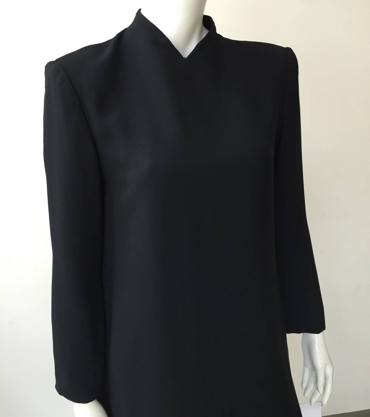 Travilla 70s minimal black layered wool dress size 12. Ladies please use your measuring tape so you can properly measure your bust, waist & hips to make certain this vintage treasure will fit you to perfection. 
Dress is lined.
Mild shoulder pads as
