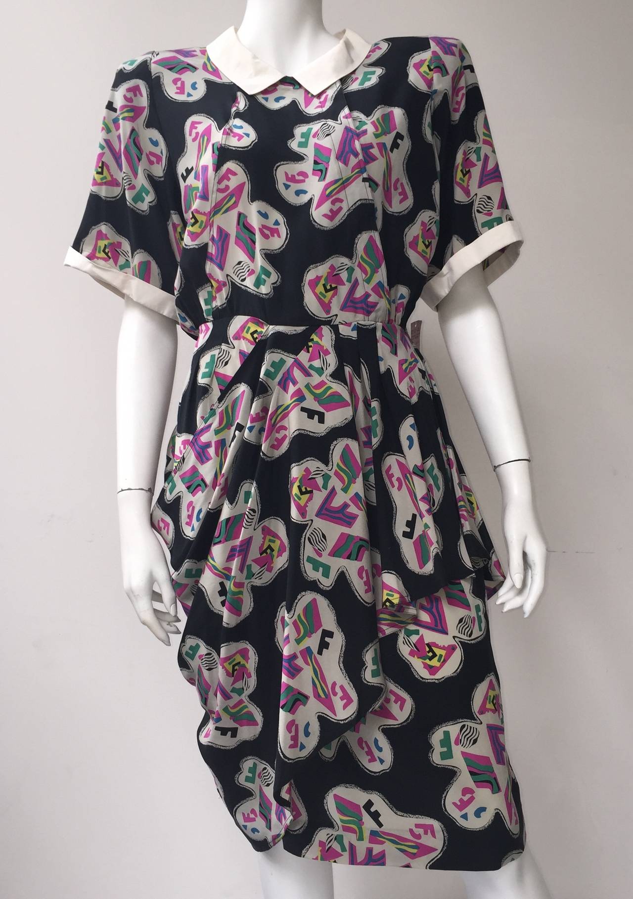 Fendi by Karl Lagerfeld for Neiman Marcus 80s still with original tag silk dress size 44 but fits like a modern day size 6 (please see & use measurements).
Powerful shoulder pads that can be removed for a more updated look.
There are 4 buttons up