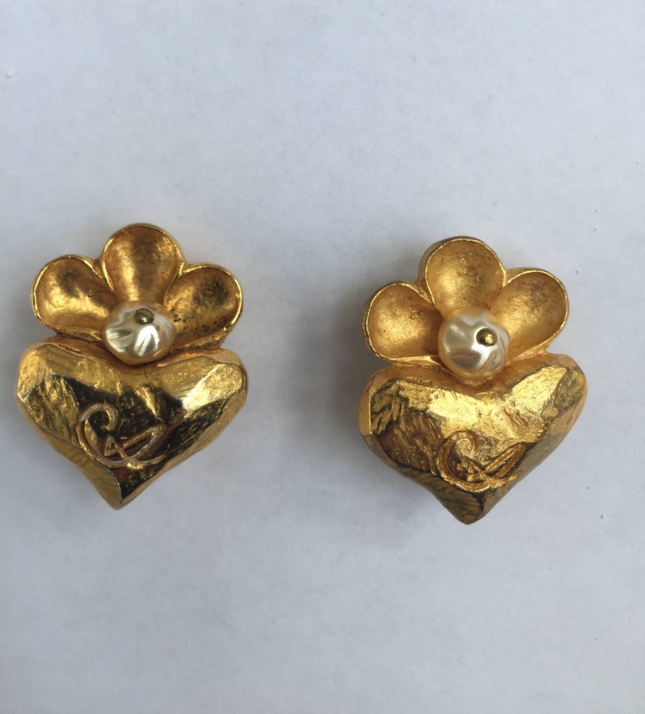 Christian Lacroix 1980s gold gilt metal flower & heart with faux pearl clip earrings. Christian Lacroix initial. 
1" wide x 1.1/4" tall.