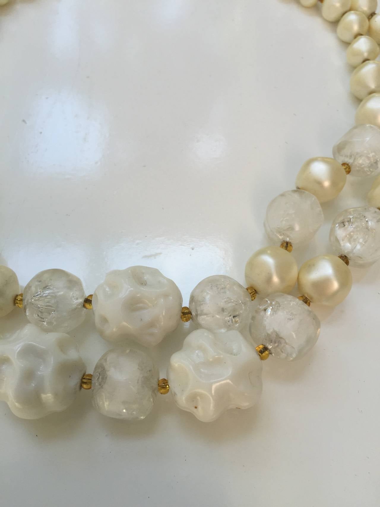Elsa Schiaparelli 1960s double strand faux cream pearls, beads, clear & white abstract beads necklace. Elsa Schiaparelli founded a fashion house in Paris in the early 20s and drove costume jewelry to the cutting edge of fashion as is shown in this