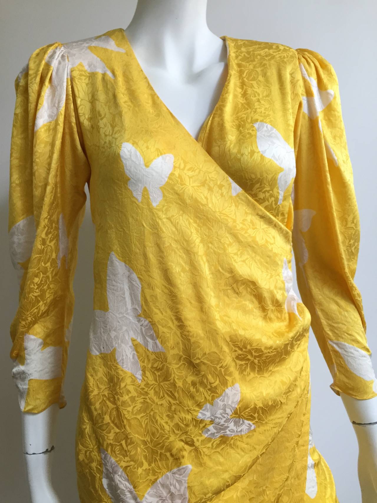 Flora Kung 1980s Asian inspired silk bold butterfly pattern wrap dress original size 2 but fits this size 4 mannequin perfectly (please see & use measurements).
Has 3 interior ties to secure wrap and fabric covered buttons at waist.

Flora was