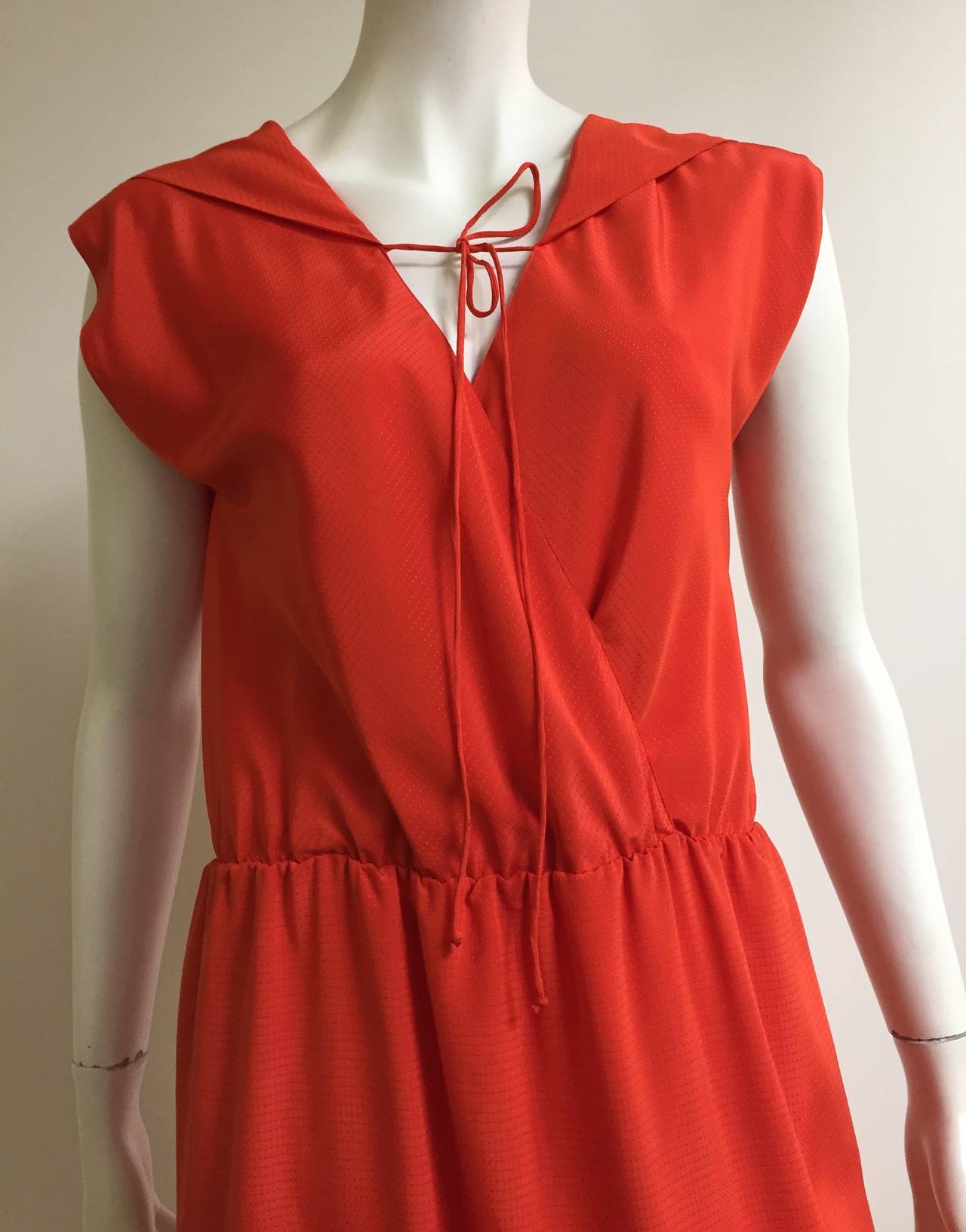 Pauline Trigere 1980s orange dress with tie string at neckline and elastic waistband. Dress is lined. Original size is small but fits today like a modern day 10 /12 but please see & use measurements. Ladies please use your measuring tape so you