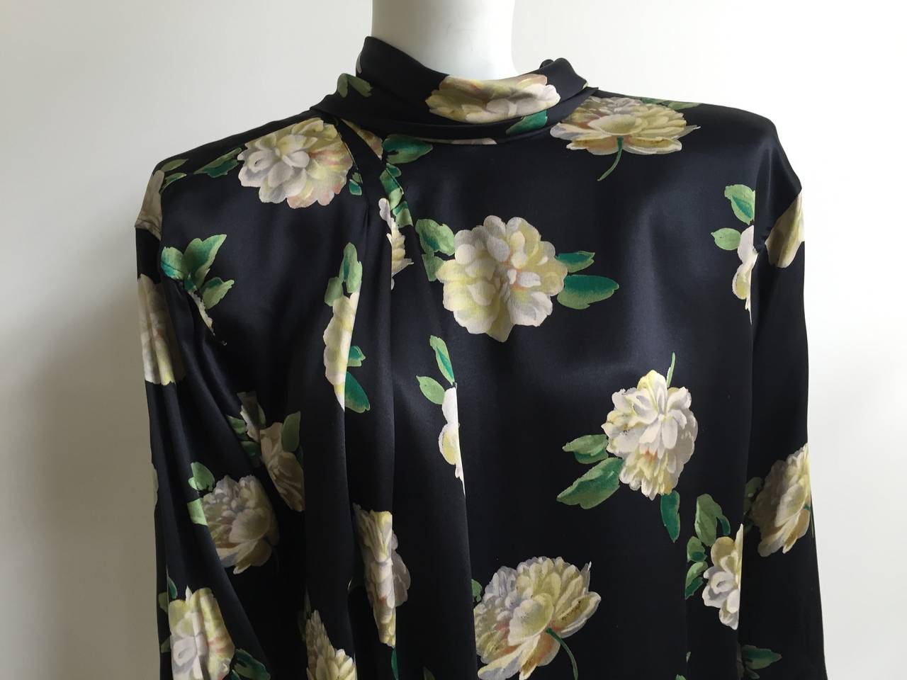 Emanuel Ungaro Parallele Paris 1980s silk dress with camellia flower pattern is made in Italy and is size 8 but will also fit a size 6 ( please see & use measurements). Zipper sleeves.  Buttons on the back with a silk scarf. Bow at bottom of hip.