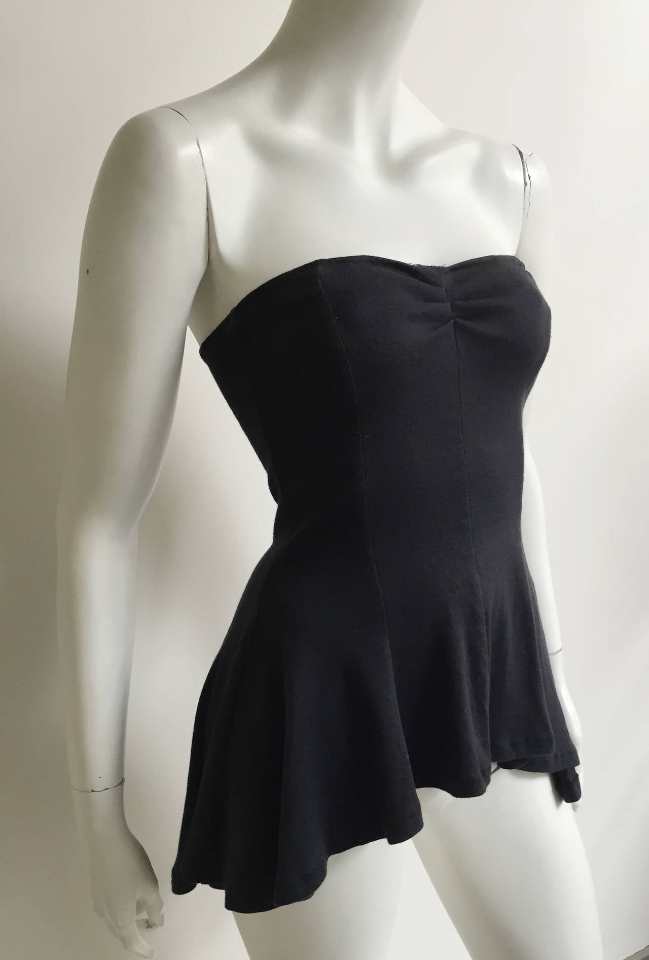 Norma Kamali 1980s black cotton strapless bodice top original size medium but fits like a small ( please see & use measurements). Perfect with your black leather skin tight vintage YSL pants. 
Measurements are:
28" bust
24"