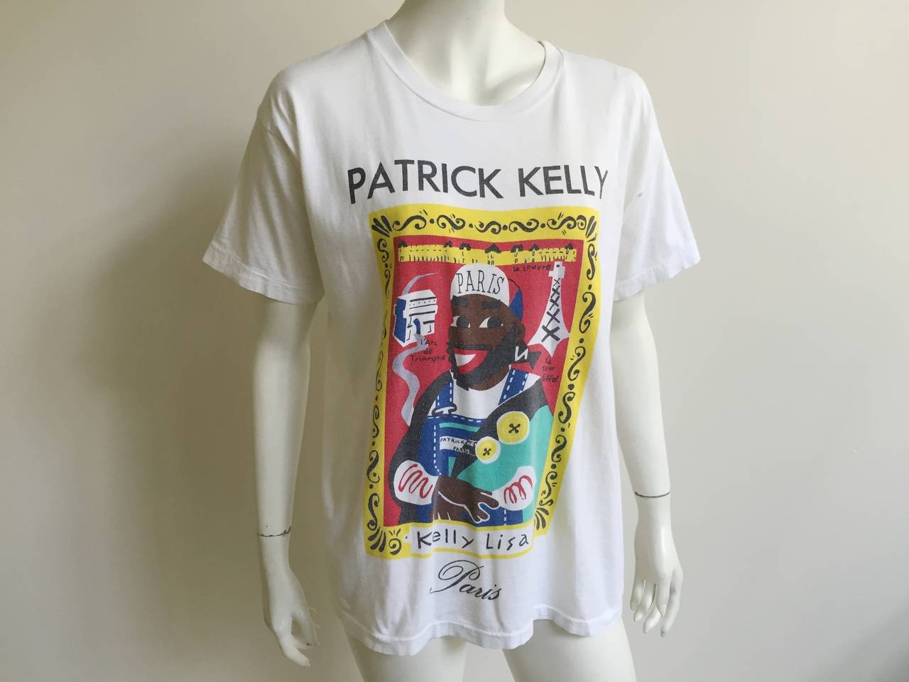 Patrick Kelly 1988 'Kelly Lisa' t-shirt is from the private collection of long time friend & model Carol Martin. Patrick Kelly adored Paris and the French adored Patrick Kelly. In this t-shirt he is paying homage to the Arc de Triomphe, The Louvre