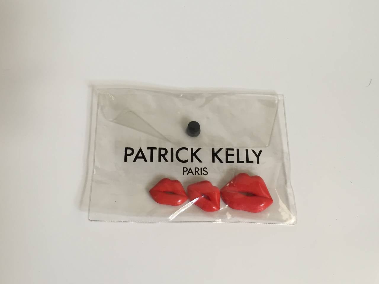 Patrick Kelly Paris 1988-1989 cellophane red 'Lips' 3 pins and original clear plastic envelope. 
In 1989 Bette Davis appeared on The David Letterman show and gave David a set of these red 'Lips' you can watch that on YouTube. These 'Lips' are from