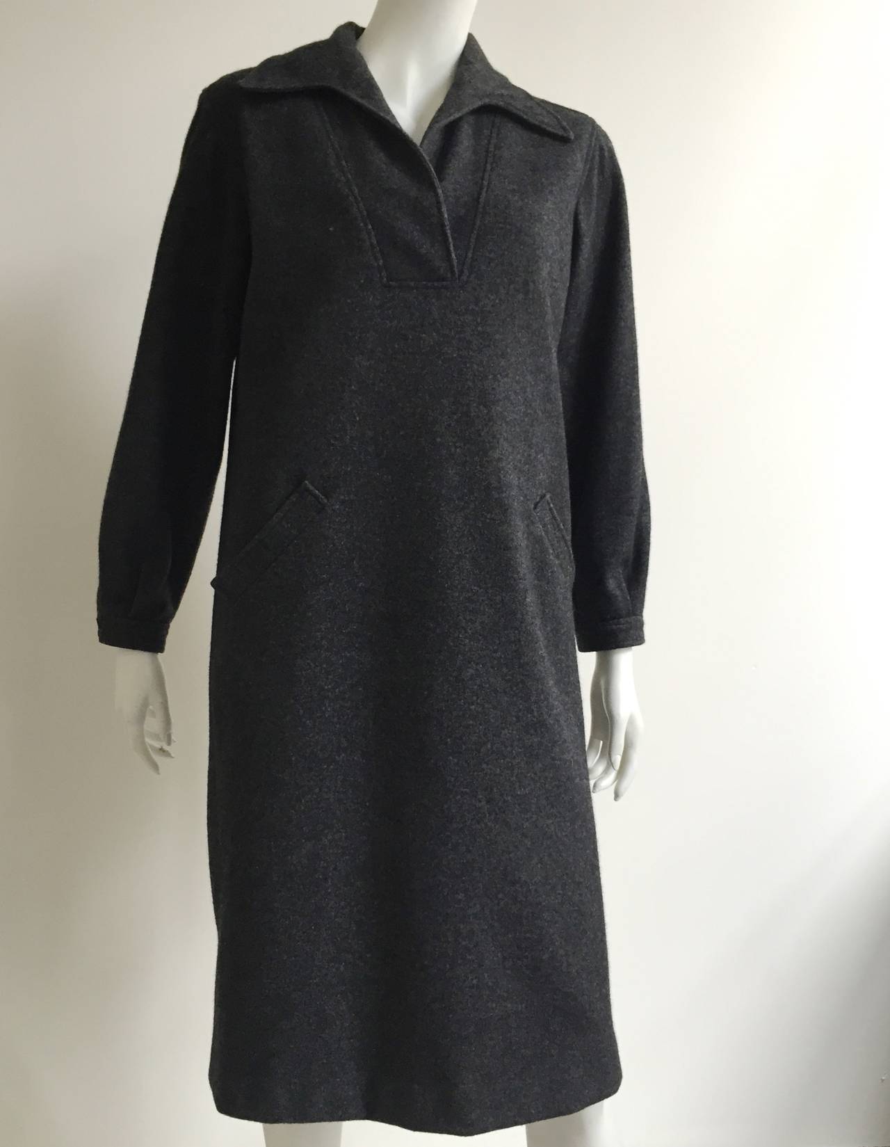 Halston 1970s thick gray wool dress with front pockets is a size 6/8. Dress is designed to be oversized, not form fitting. 
Dress is lined and made in the USA.
Measurements are:
41